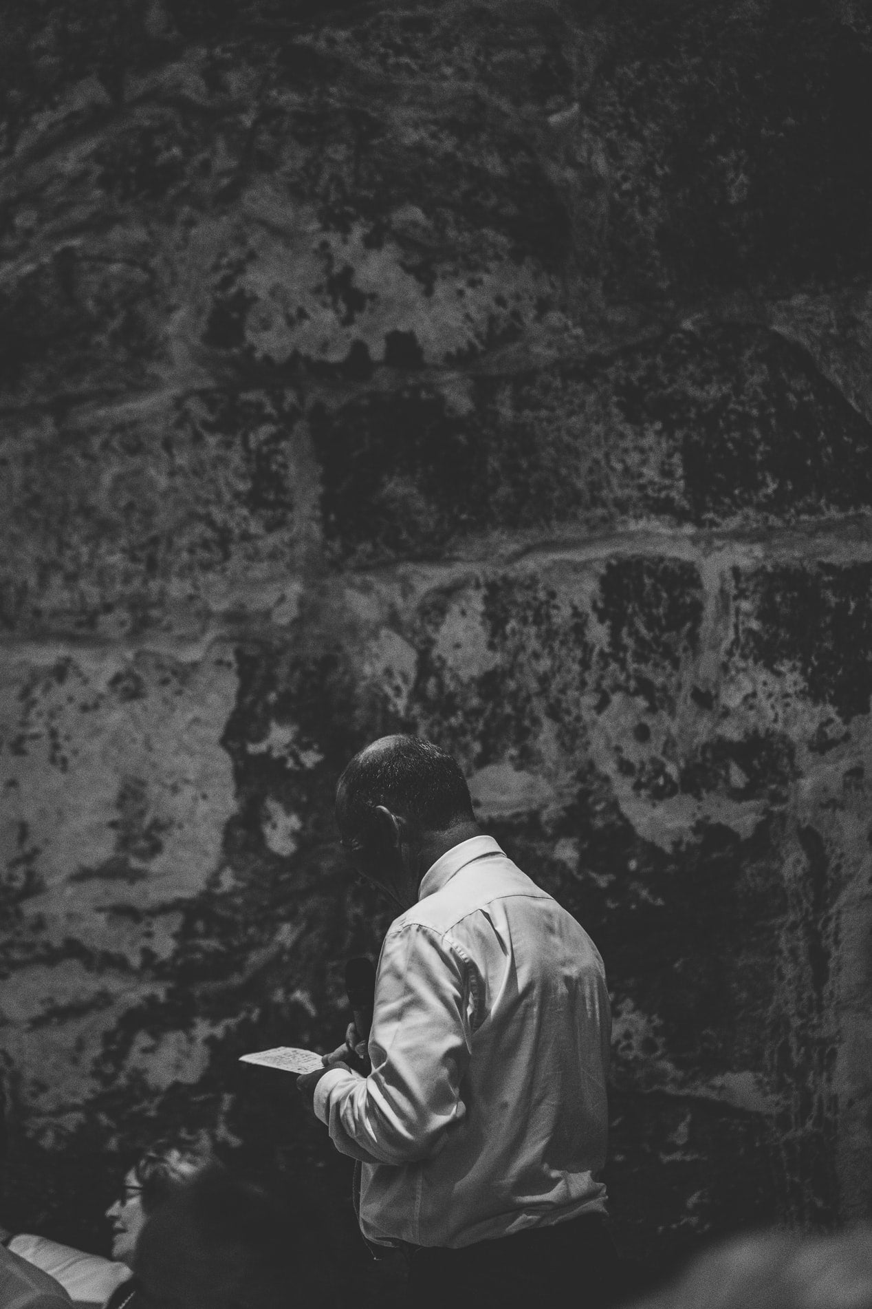 best man writing wedding speech in dark concrete room