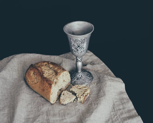 bread and a wine mug on table