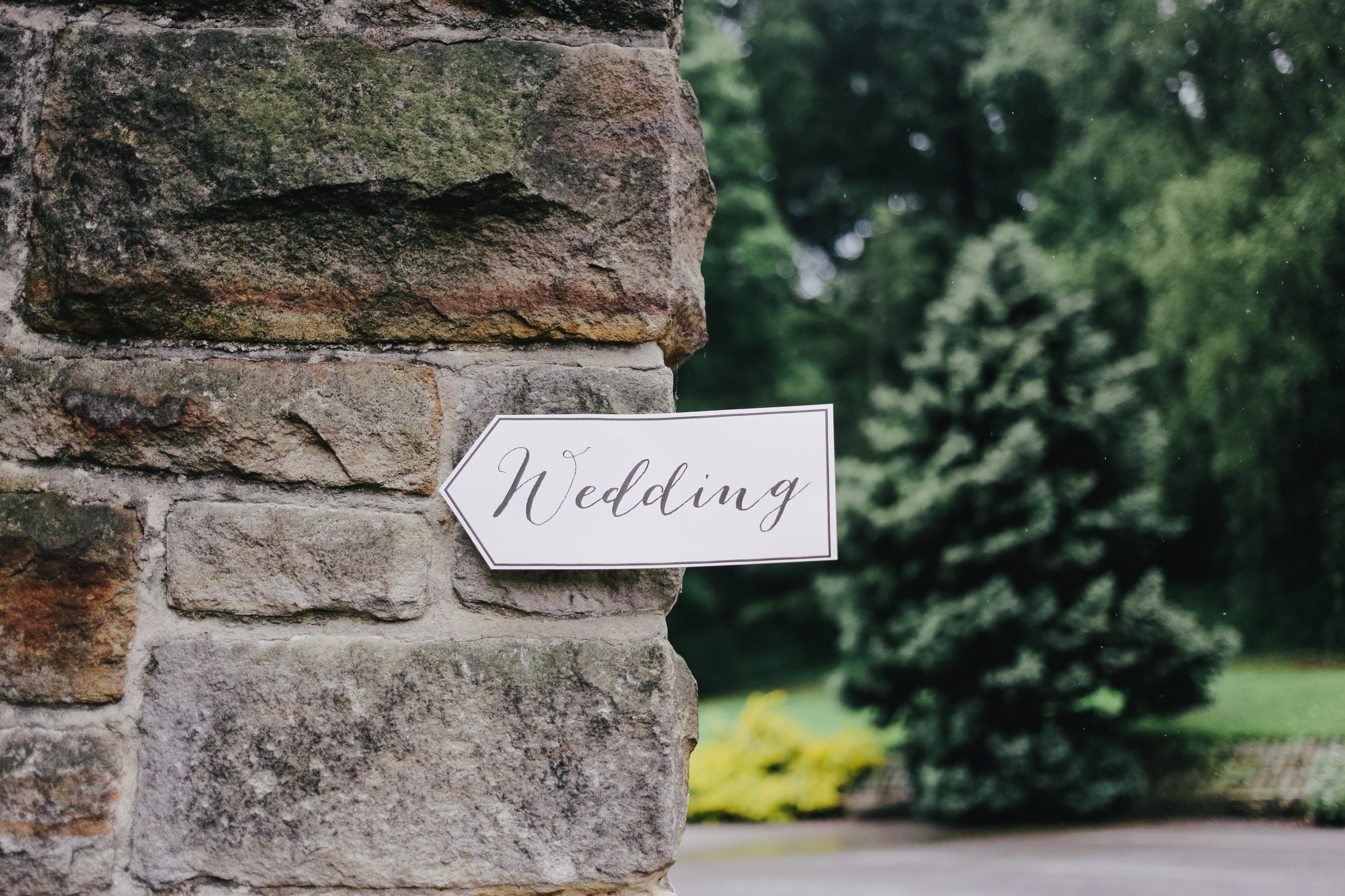 brick wall with a wedding sign at a wedding venue