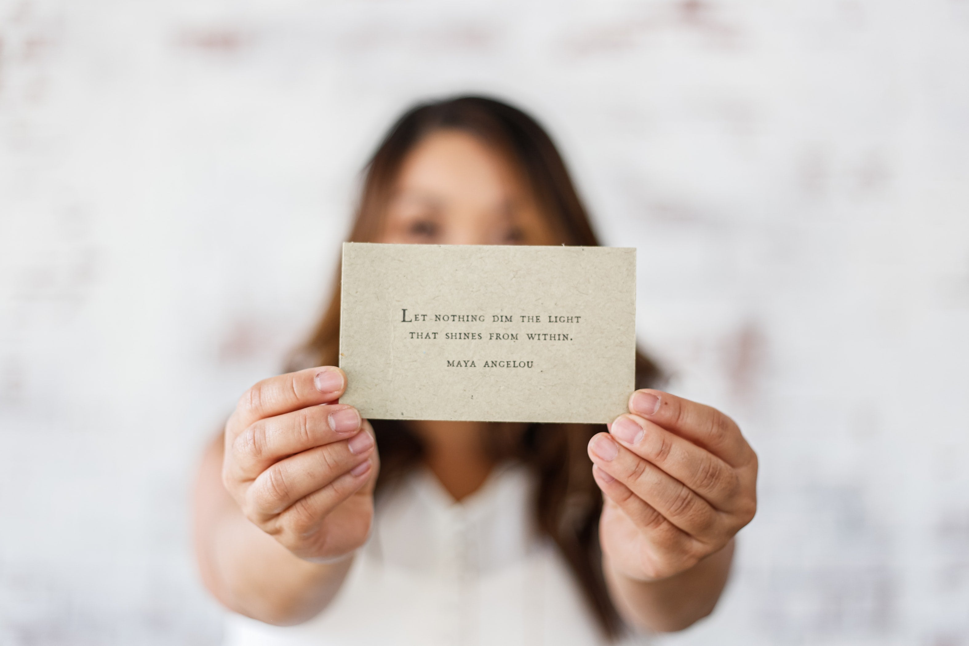 bride holding Maya Angelou quote on card