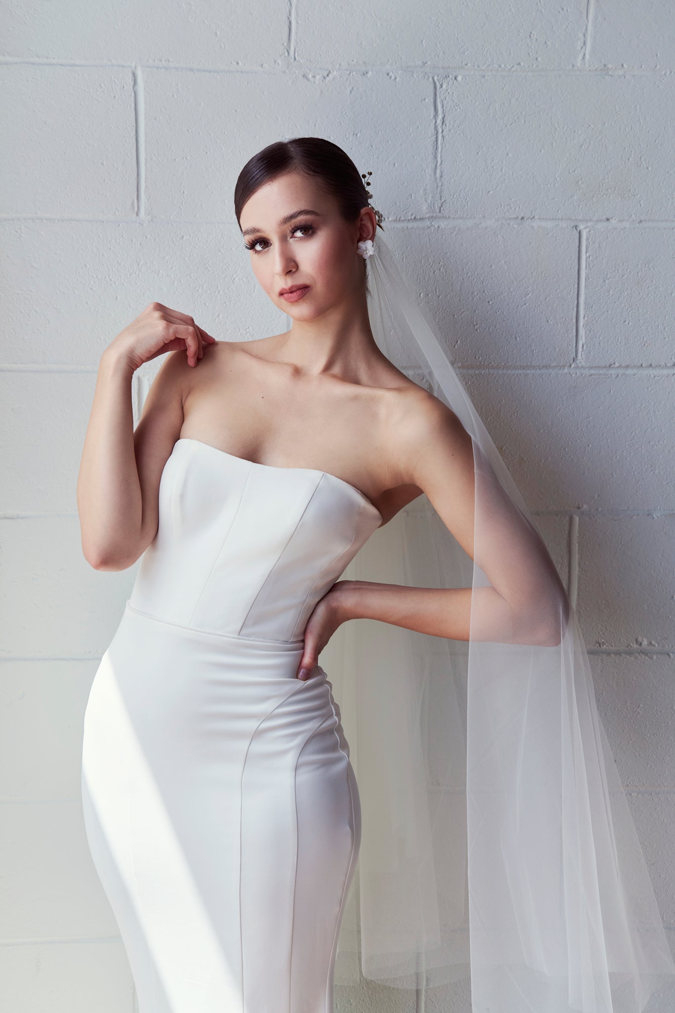 bride wearing veil and strapless ivory wedding gown
