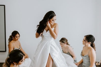 bridesmaids helping bride get ready