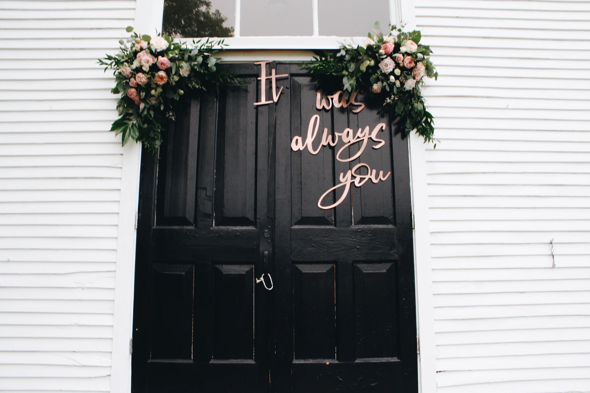 decorated black door with flowers and it was always you written on the doors
