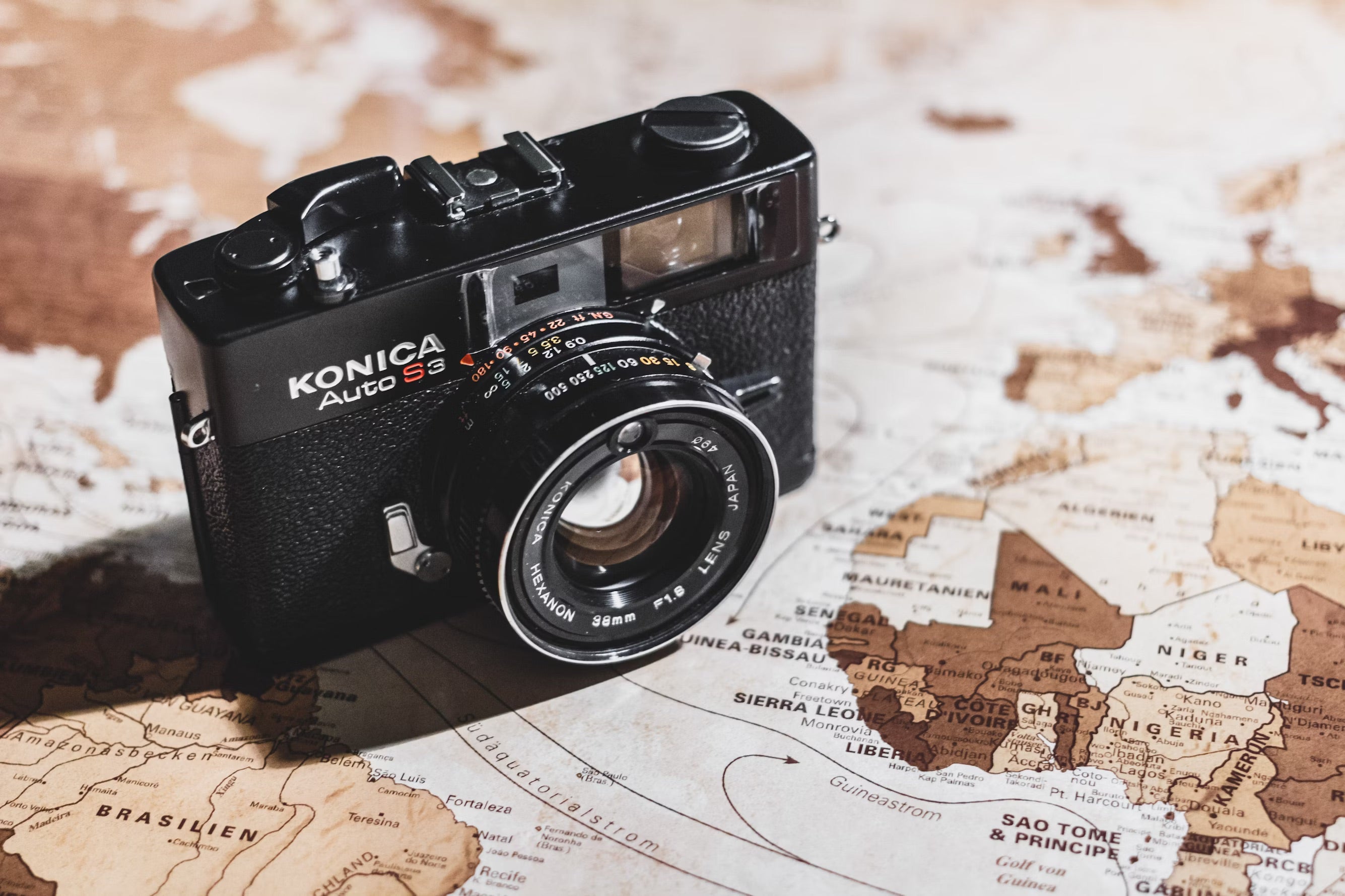 film camera on top of globe
