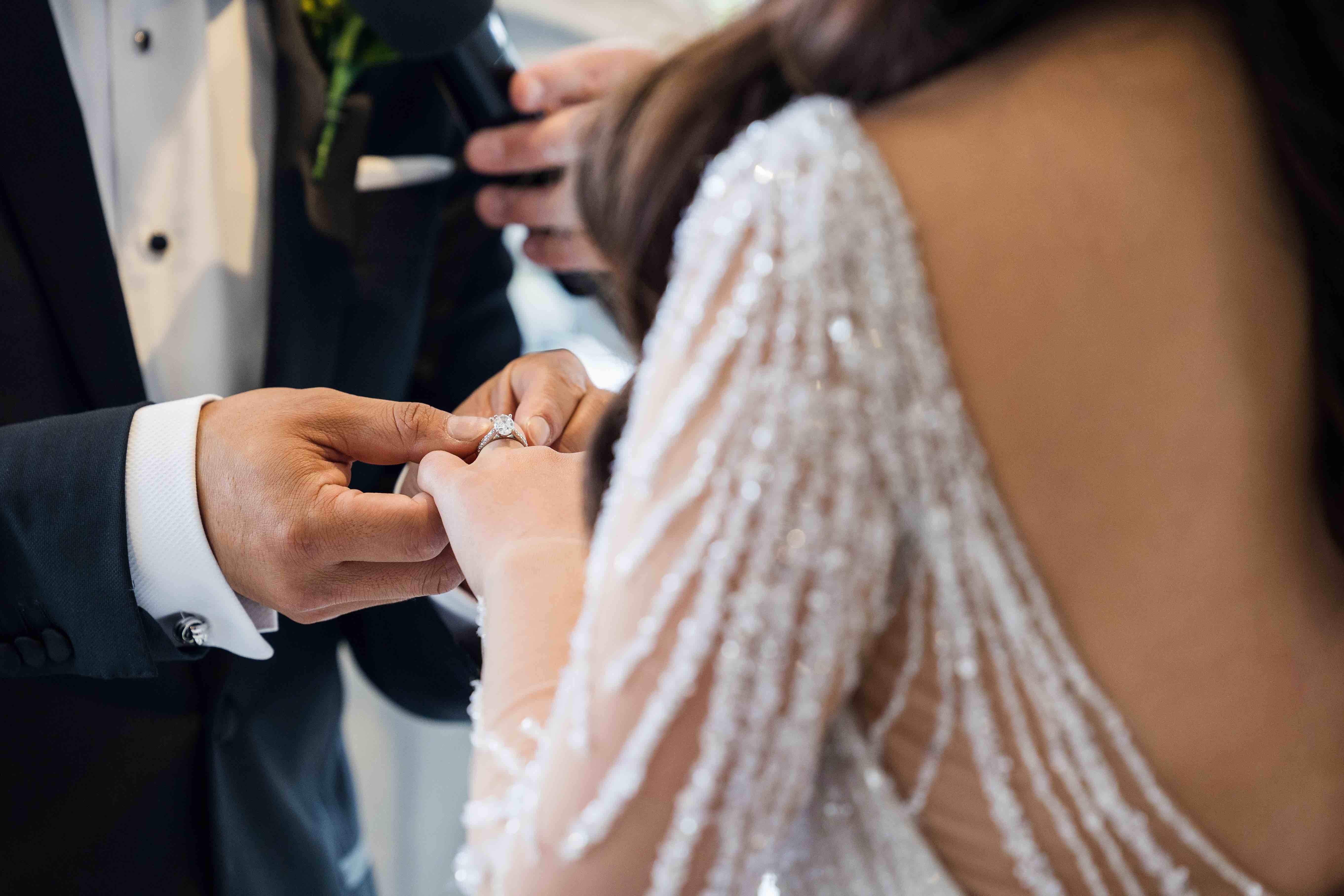 husband placing ring of wife's finger