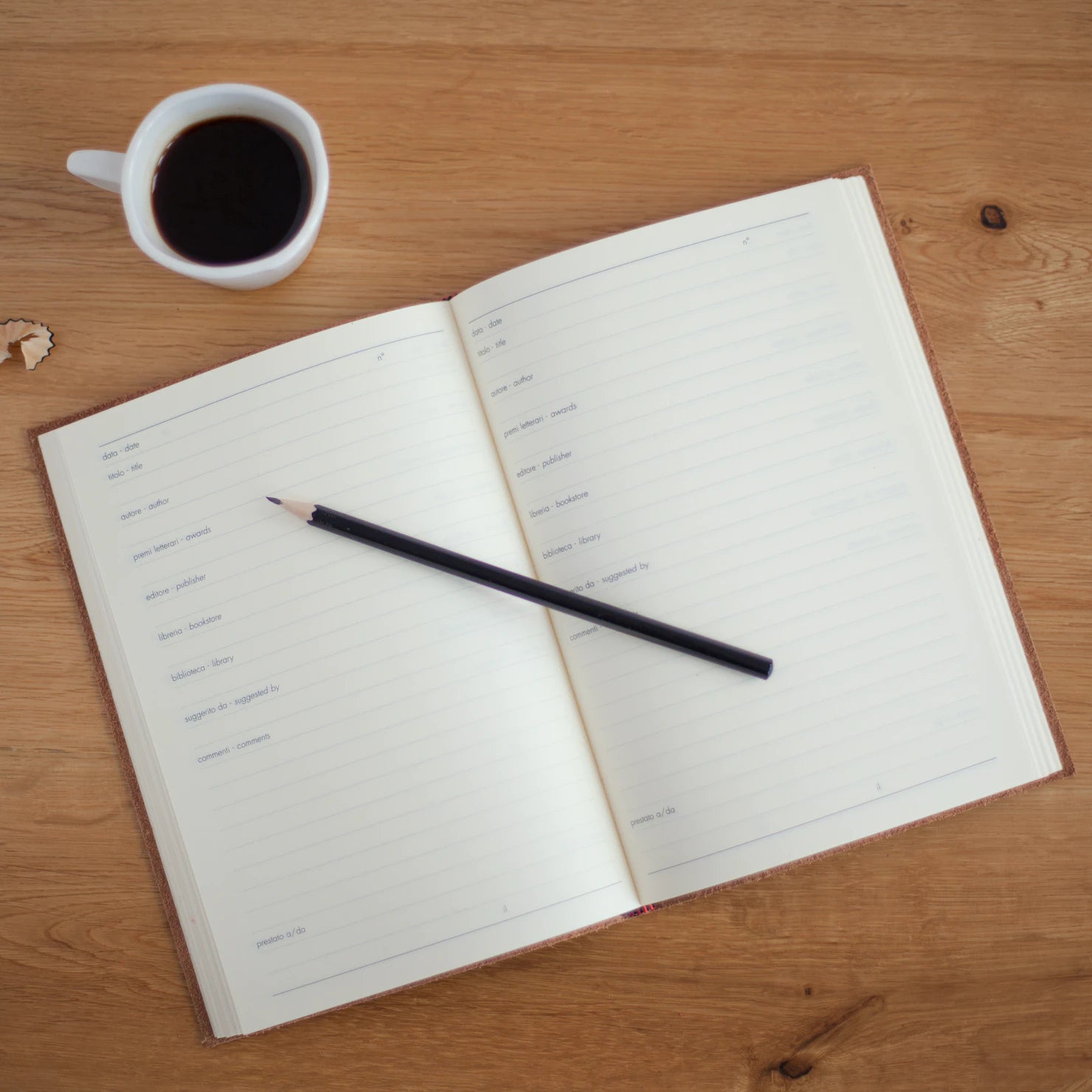 journal and coffee mug on wooden table