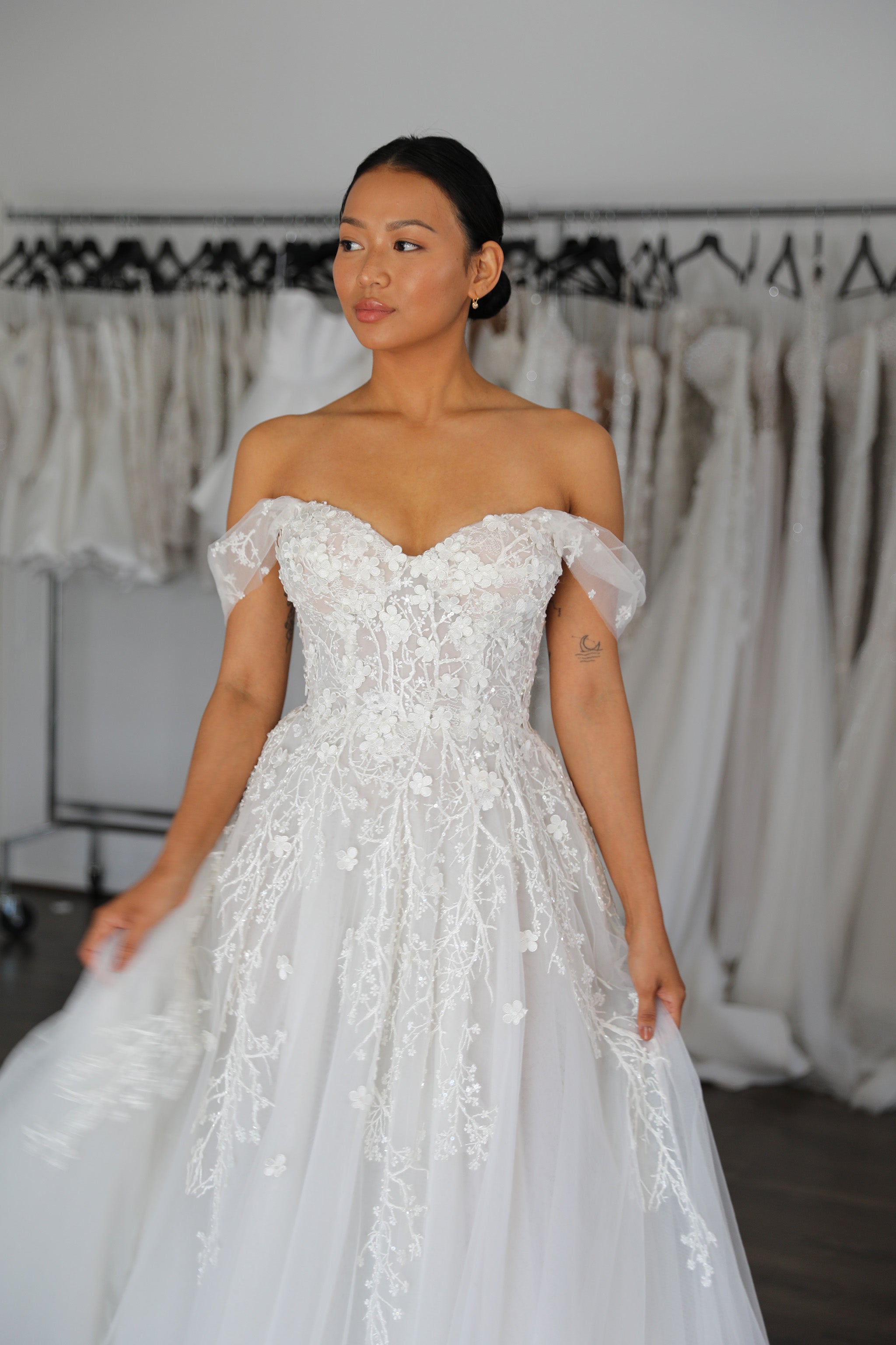 off the shoulder sleeves and sweetheart neckline on full length wedding dress