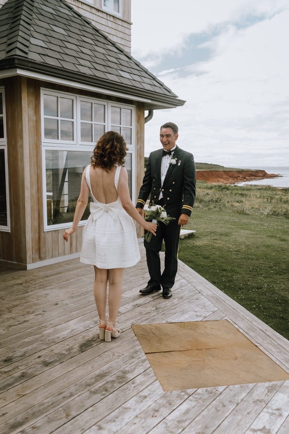 smiling husband seeing his bride for the first time on their wedding day