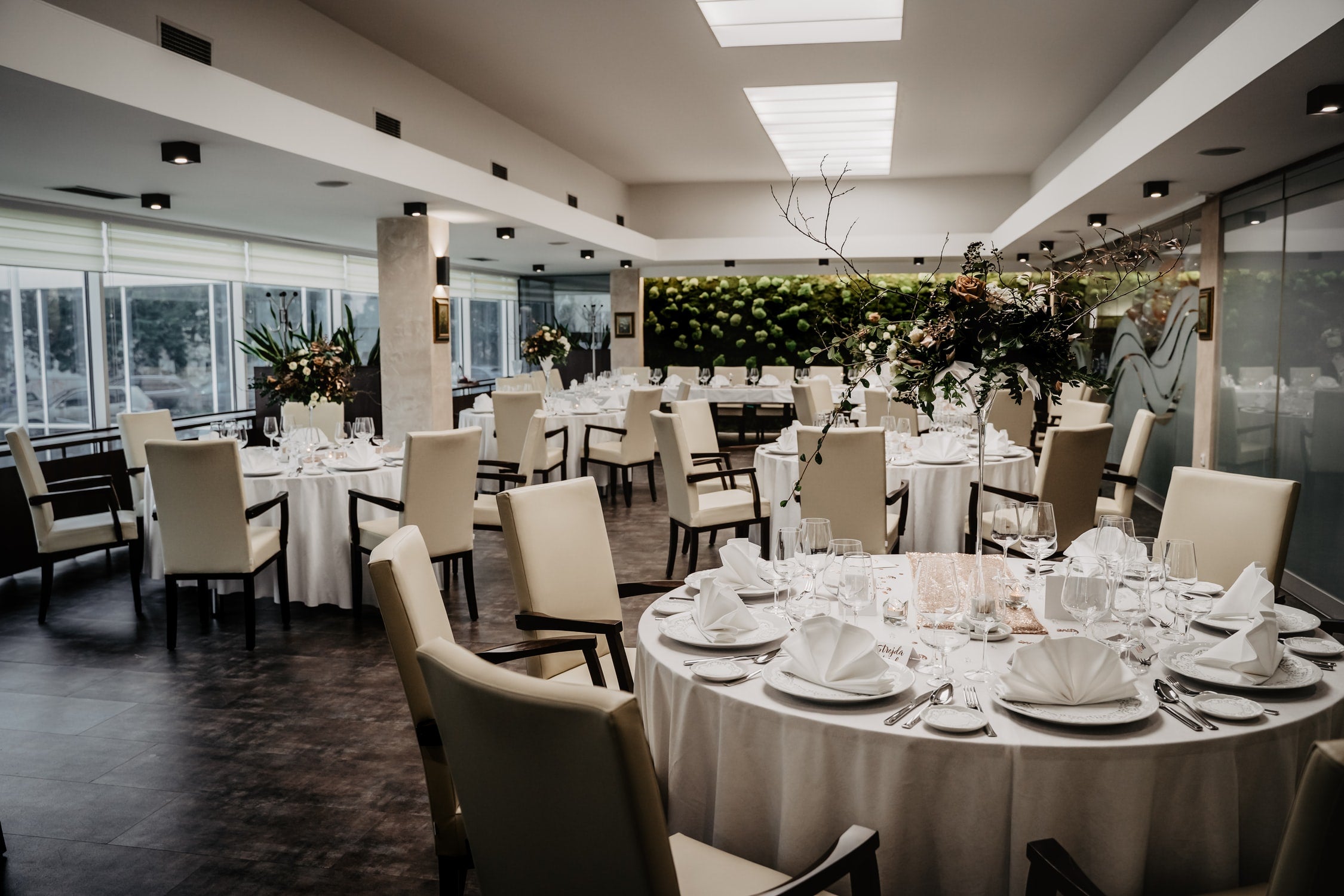 wedding reception room with tables chairs and wedding decor