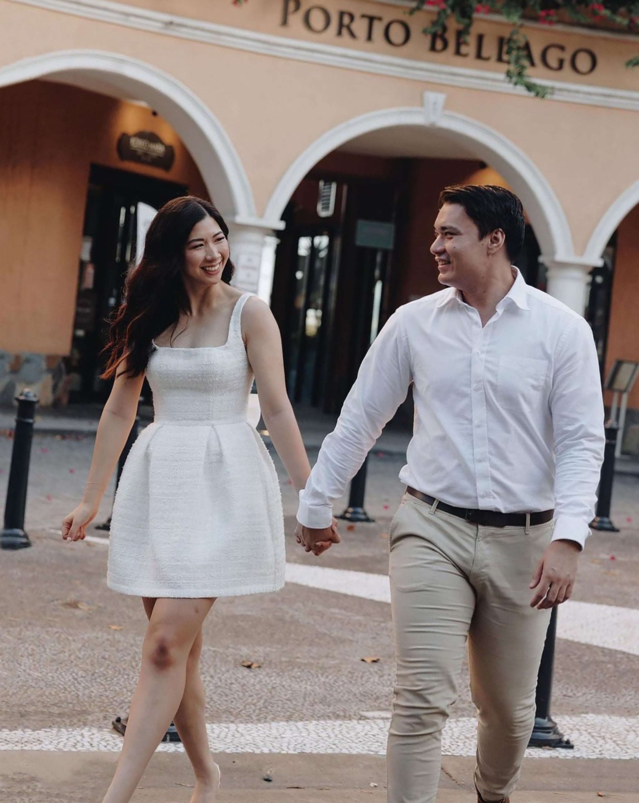 bride and groom holding hands walking through hotel