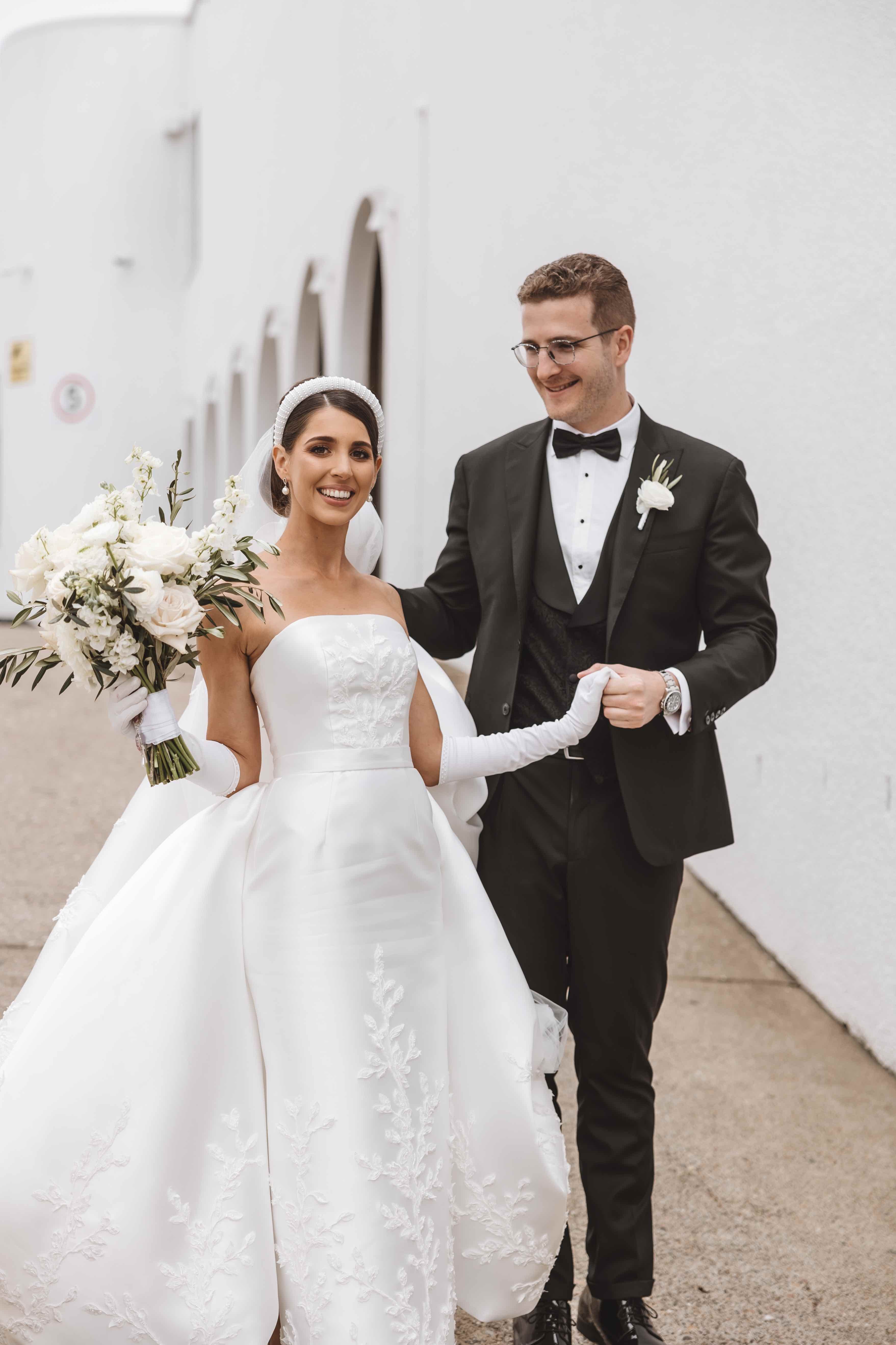 bride and groom walking hand in hand