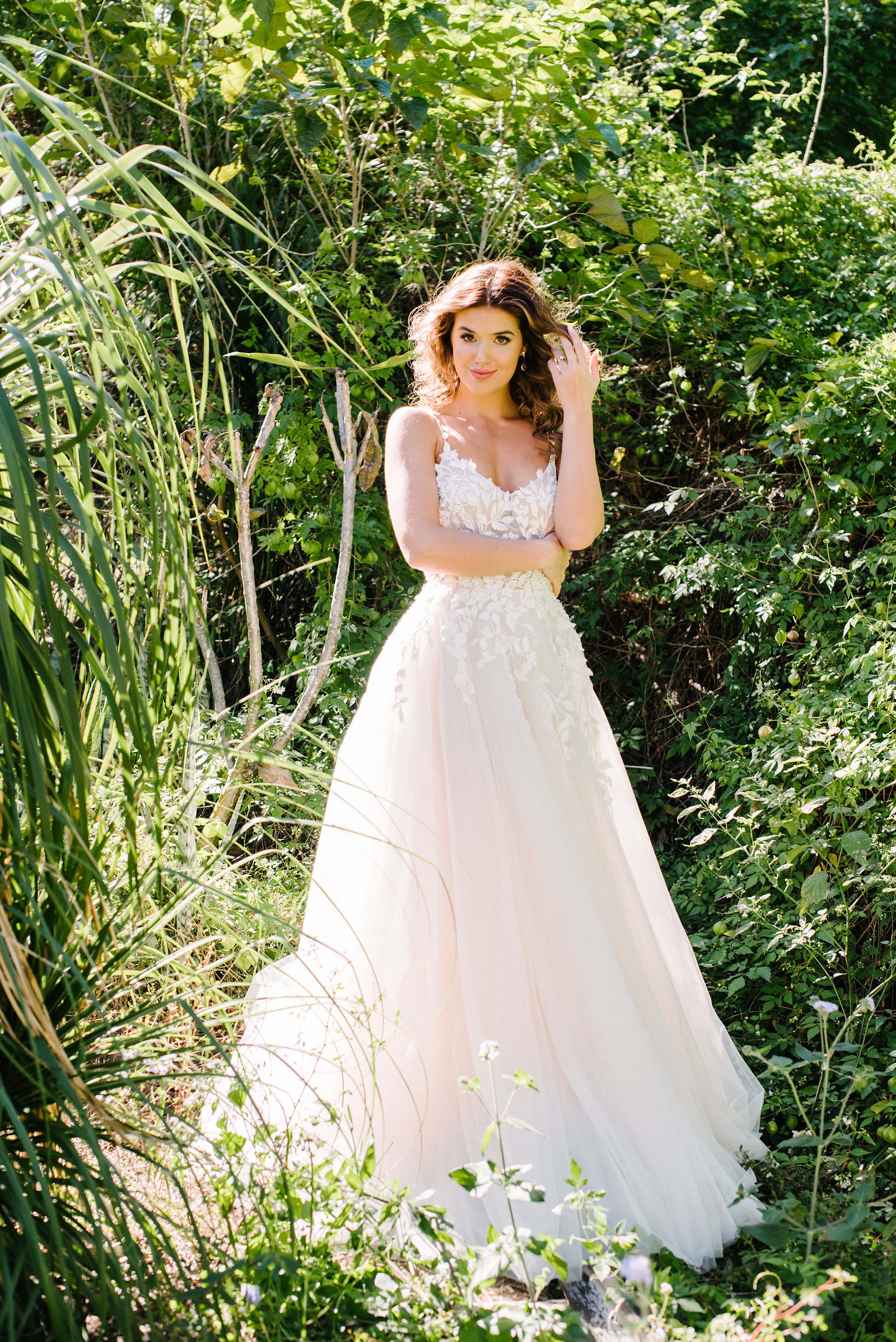bride in green garden wearing wedding dress