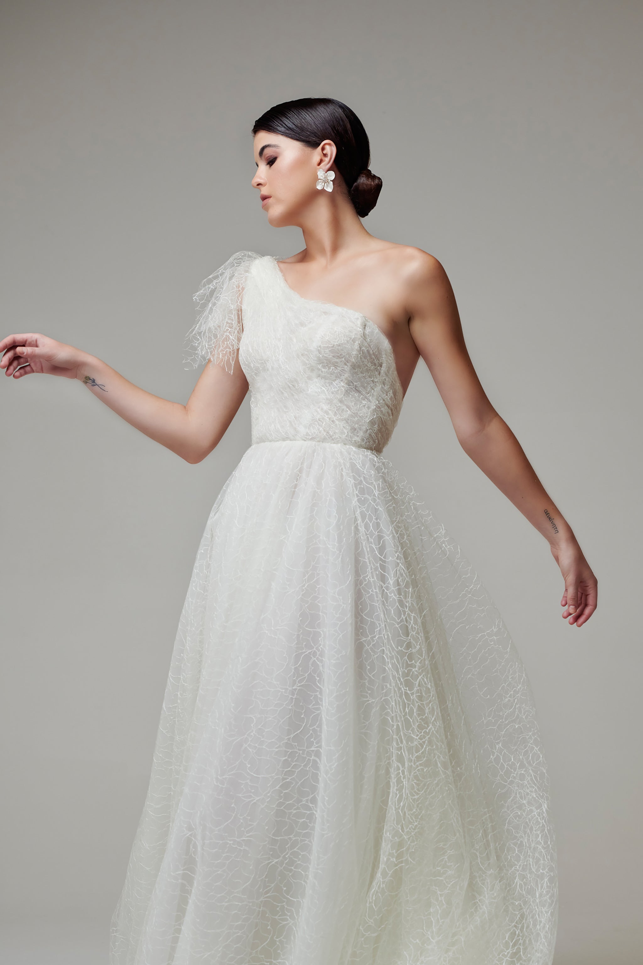 bride in lace wedding dress with one shoulder design