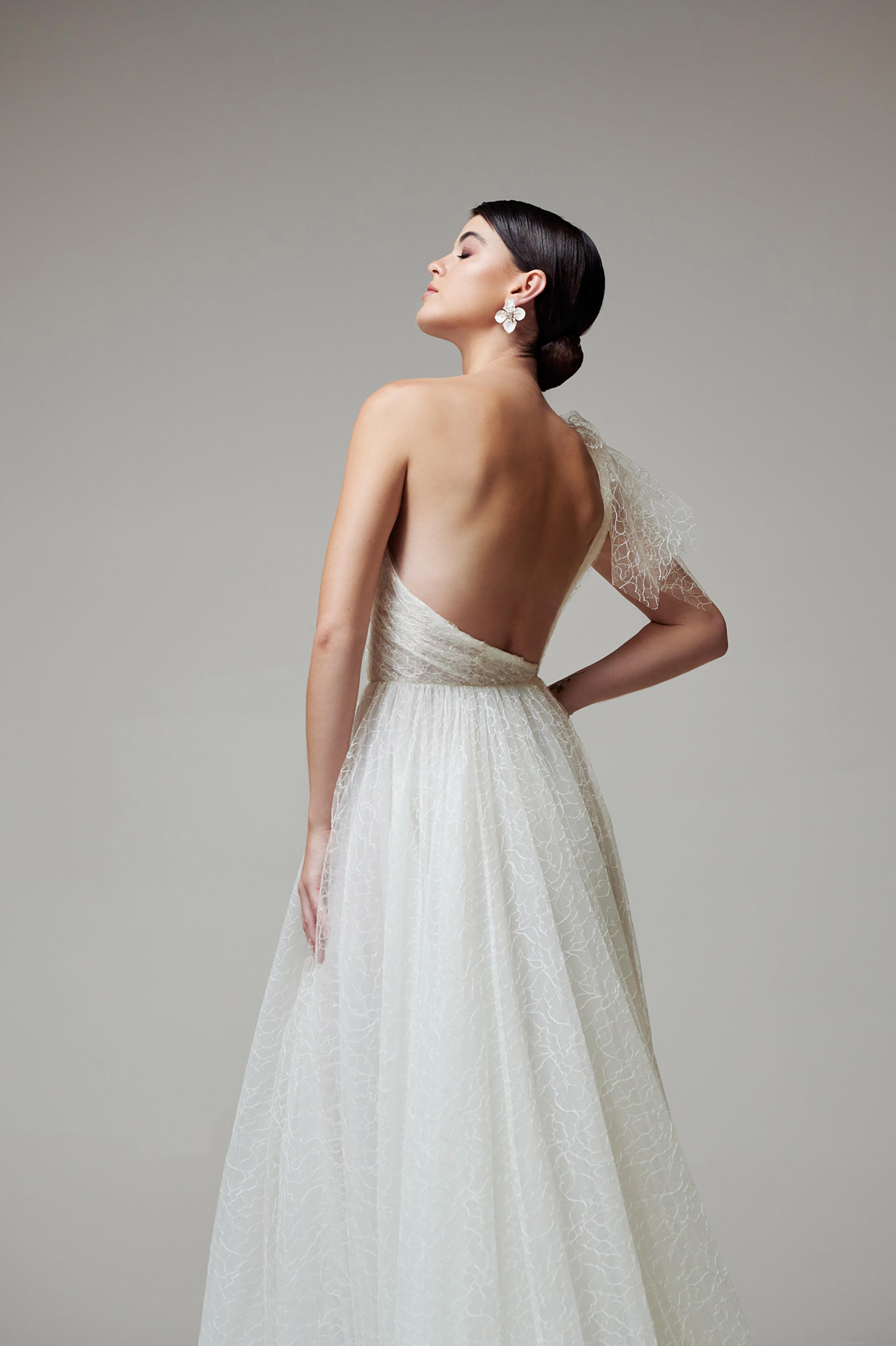 bride in low back wedding dress with one shoulder strap