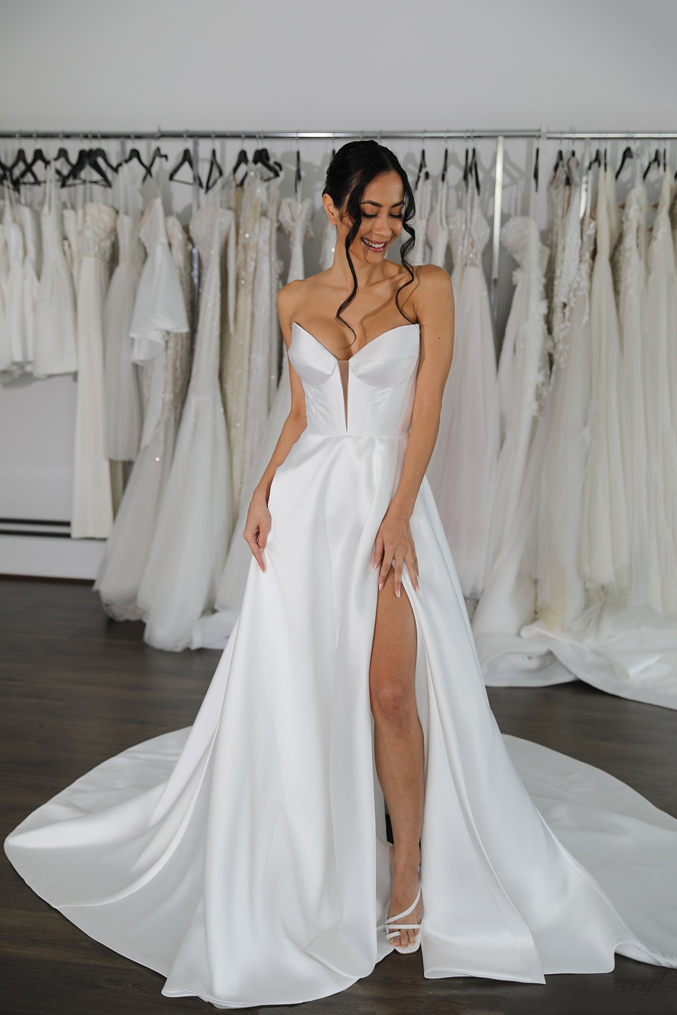 bride showcasing skirt split on her mikado wedding dress
