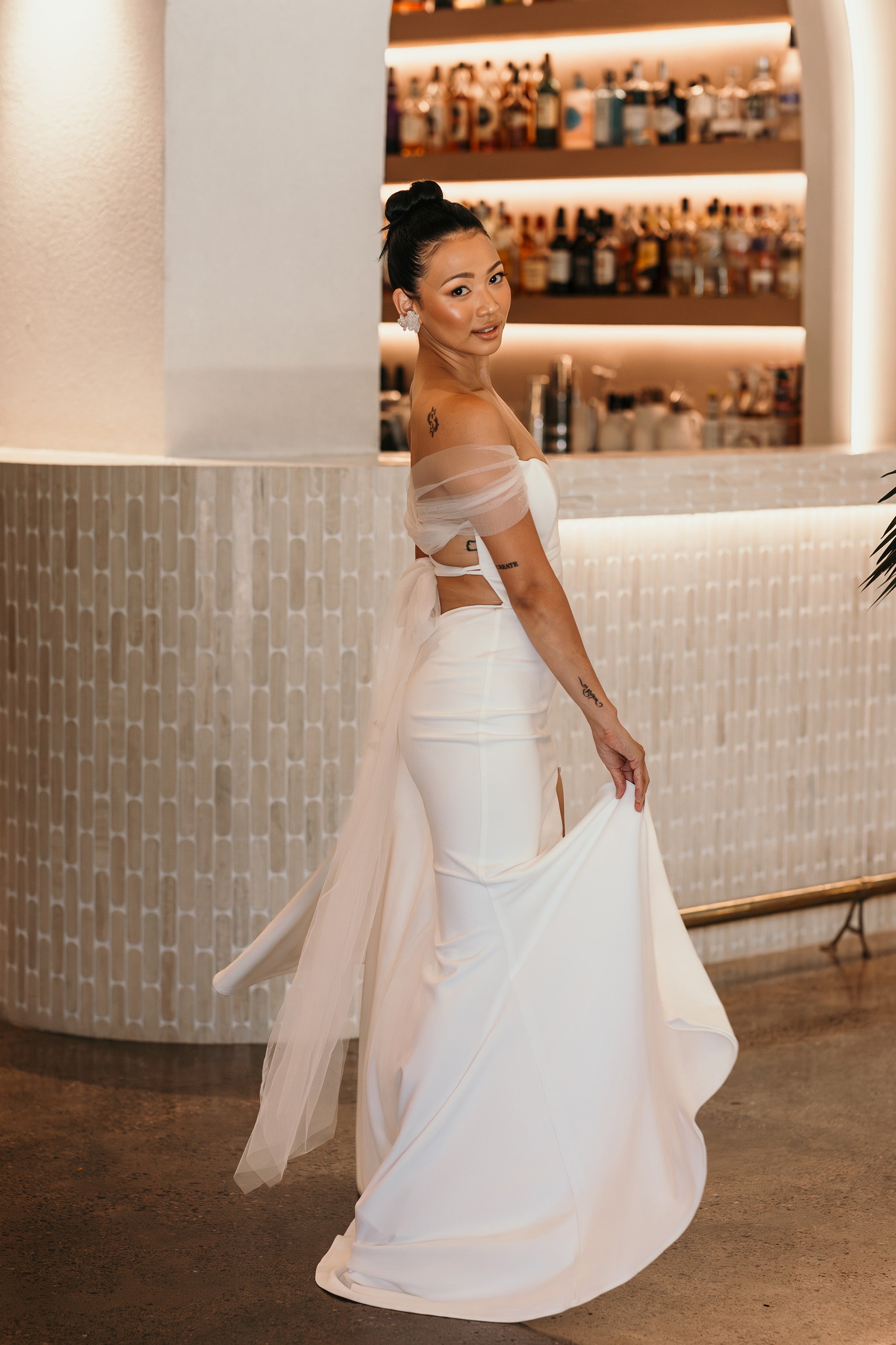 bride twirling the skirt on her gown