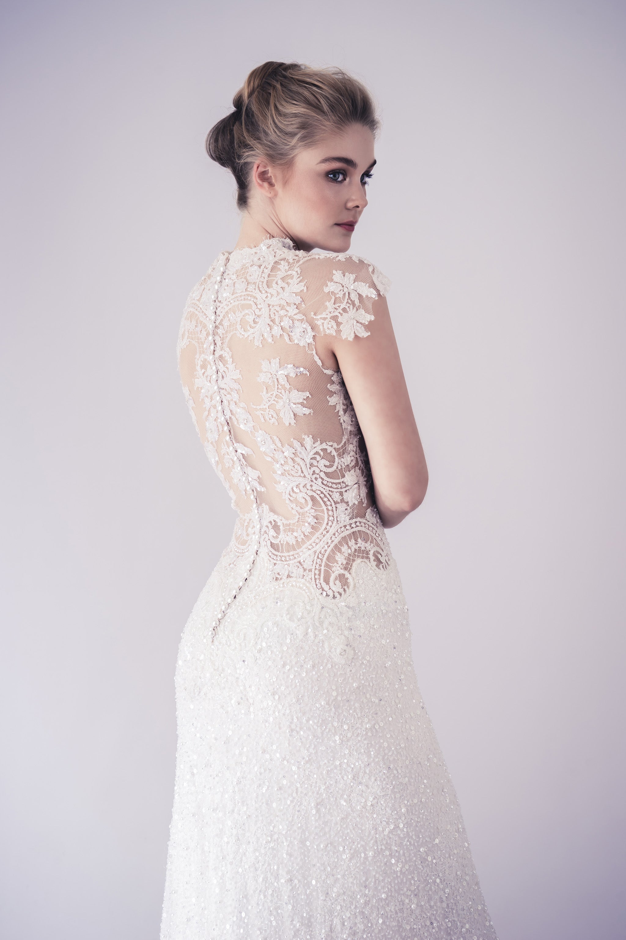 bride wearing fitted beaded lace wedding gown