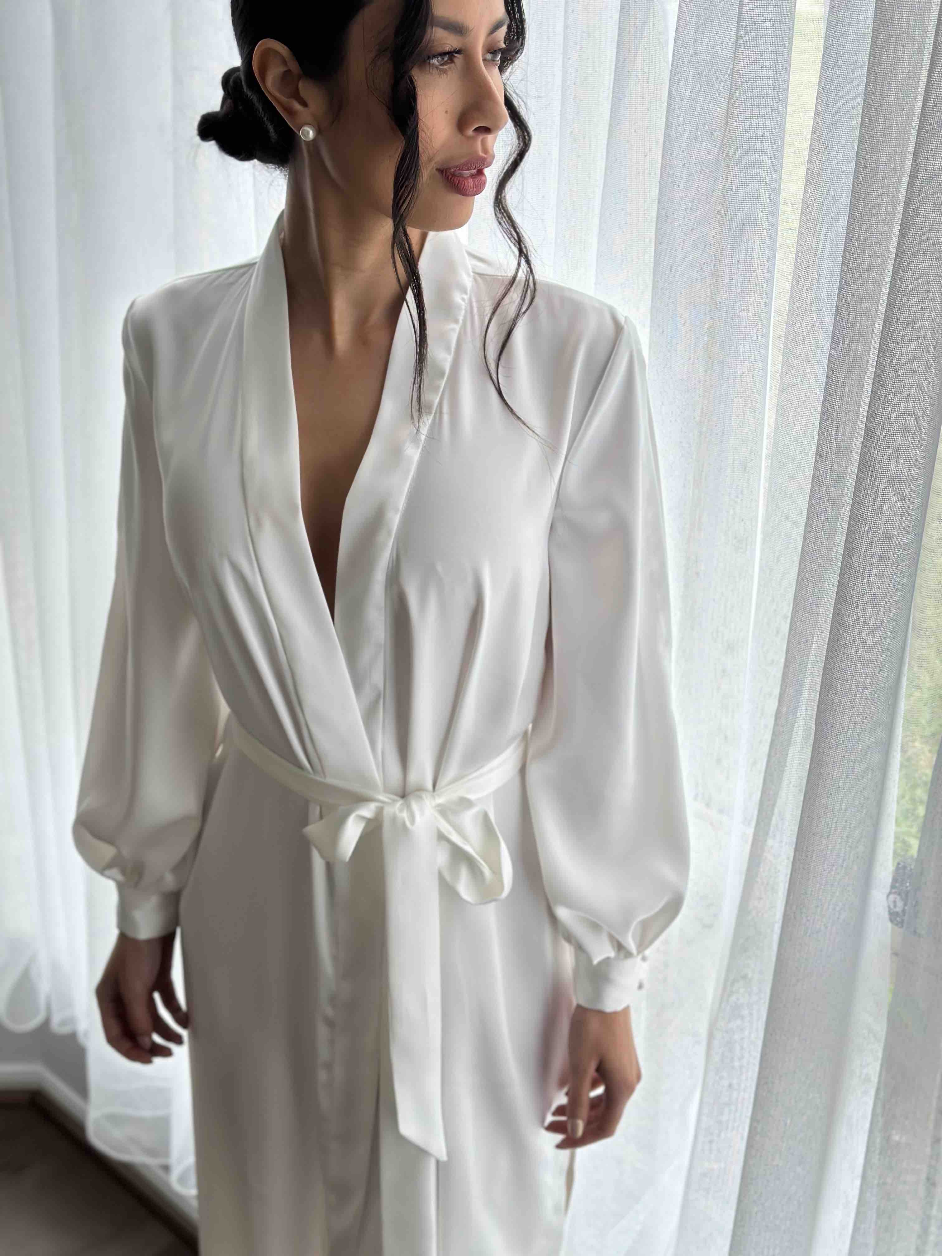 bride wearing long sleeves robe on her wedding day