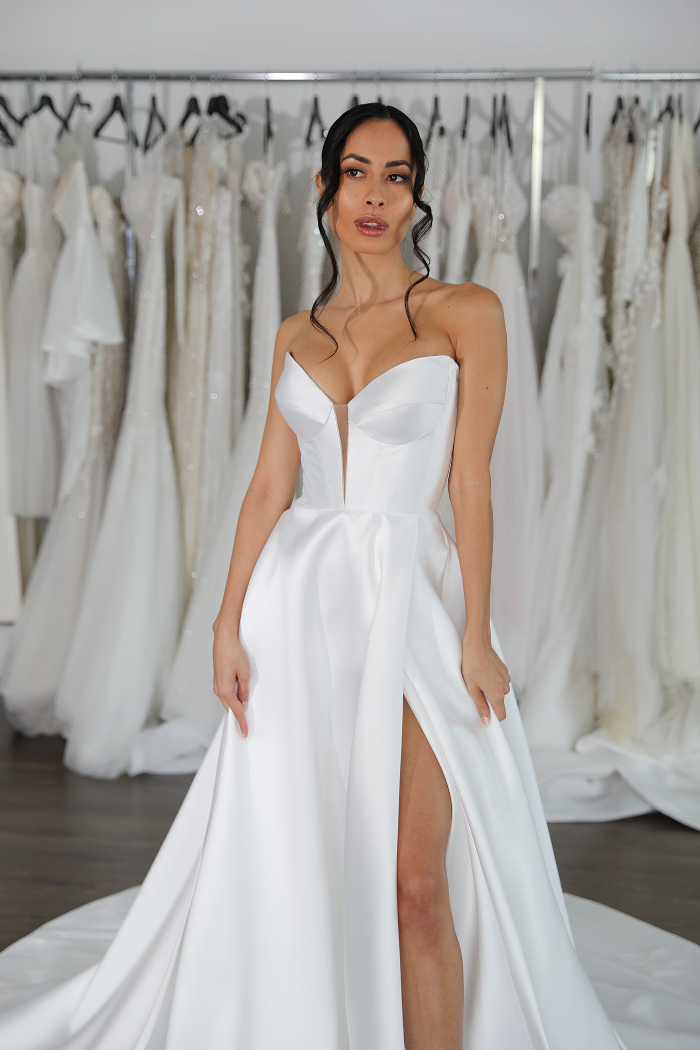 bride wearing mikado wedding dress with strapless v-neckline and skirt split