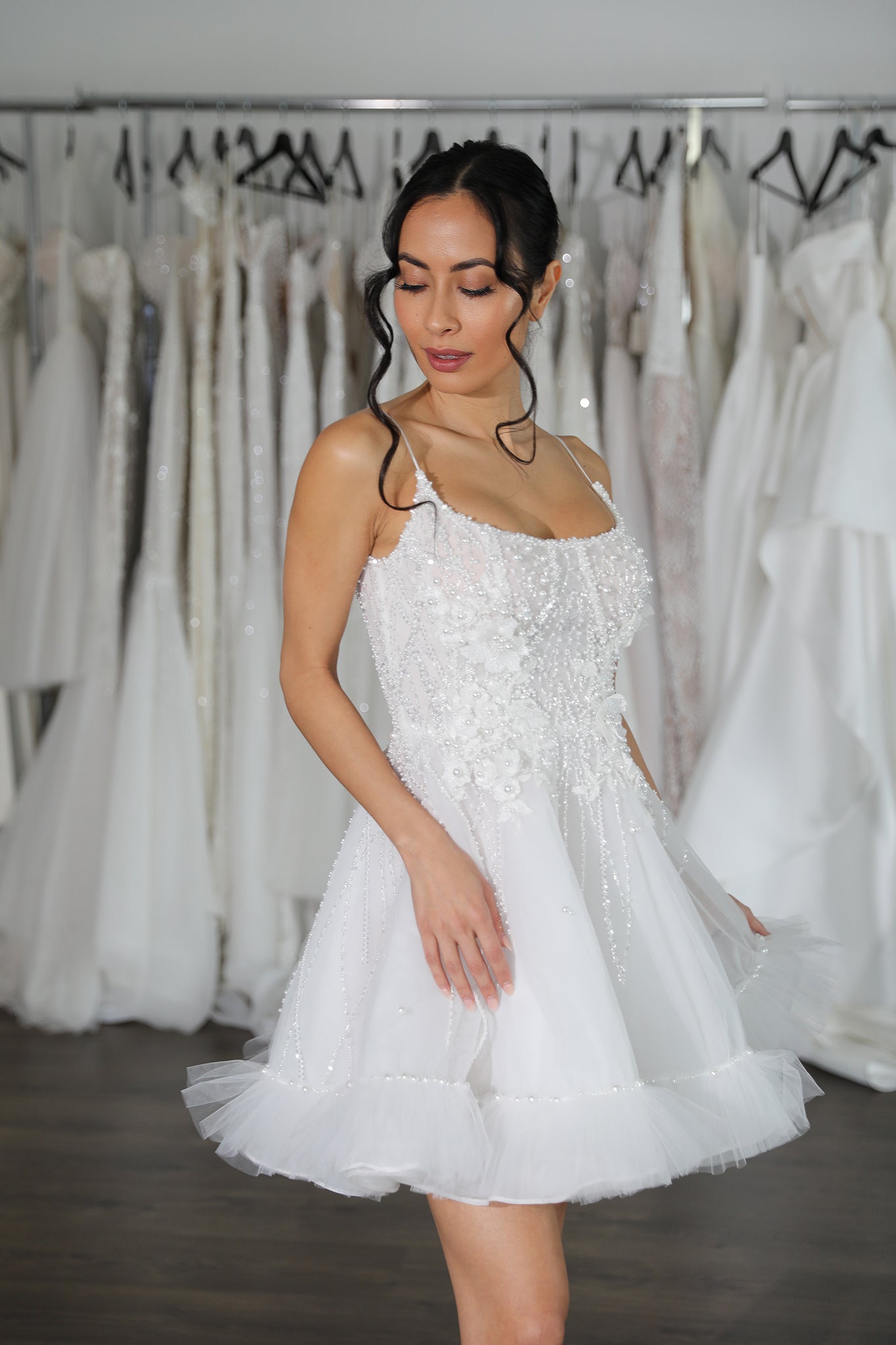 bride wearing mini wedding dress with pearl details