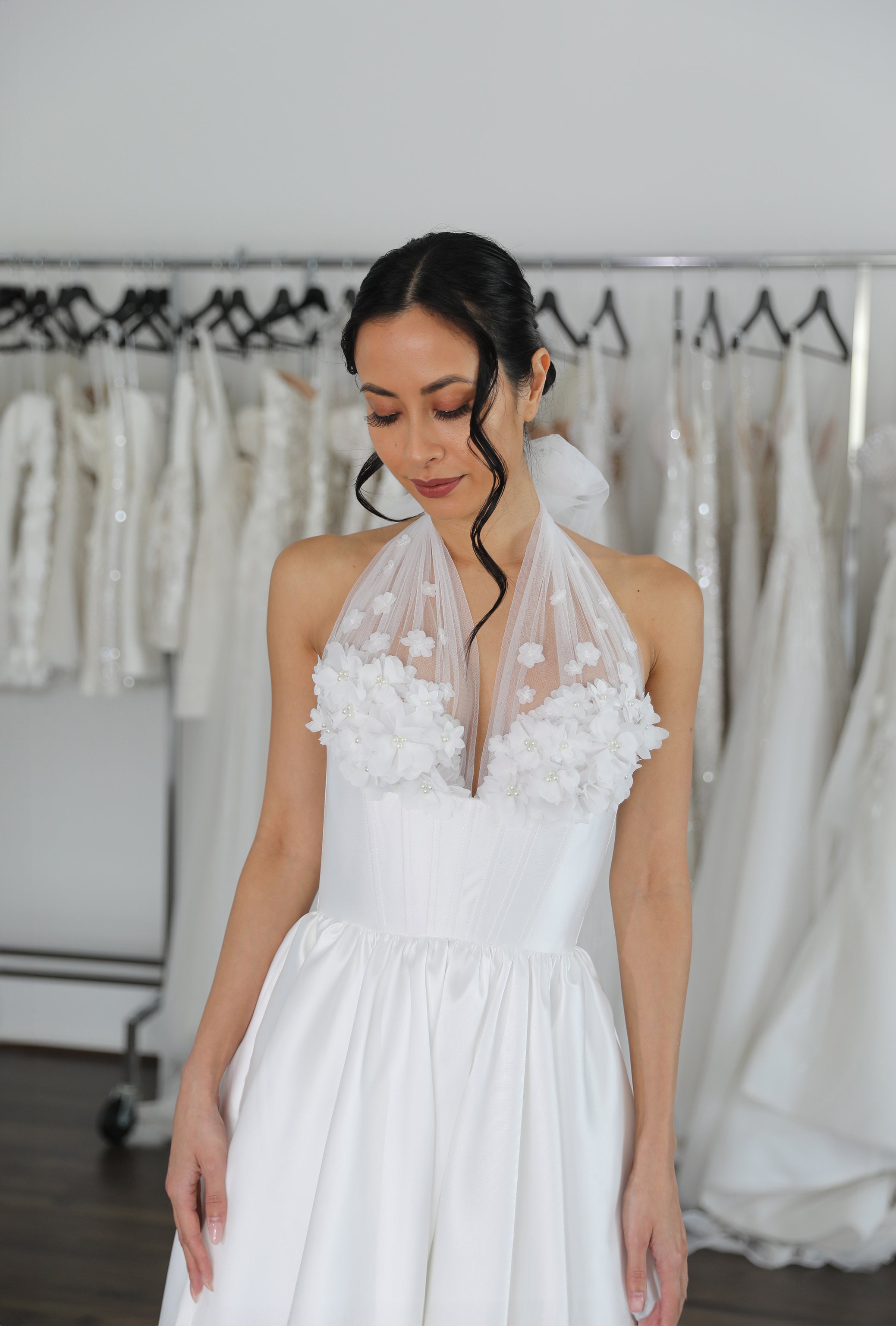 bride wearing wedding dress in bridal showroom