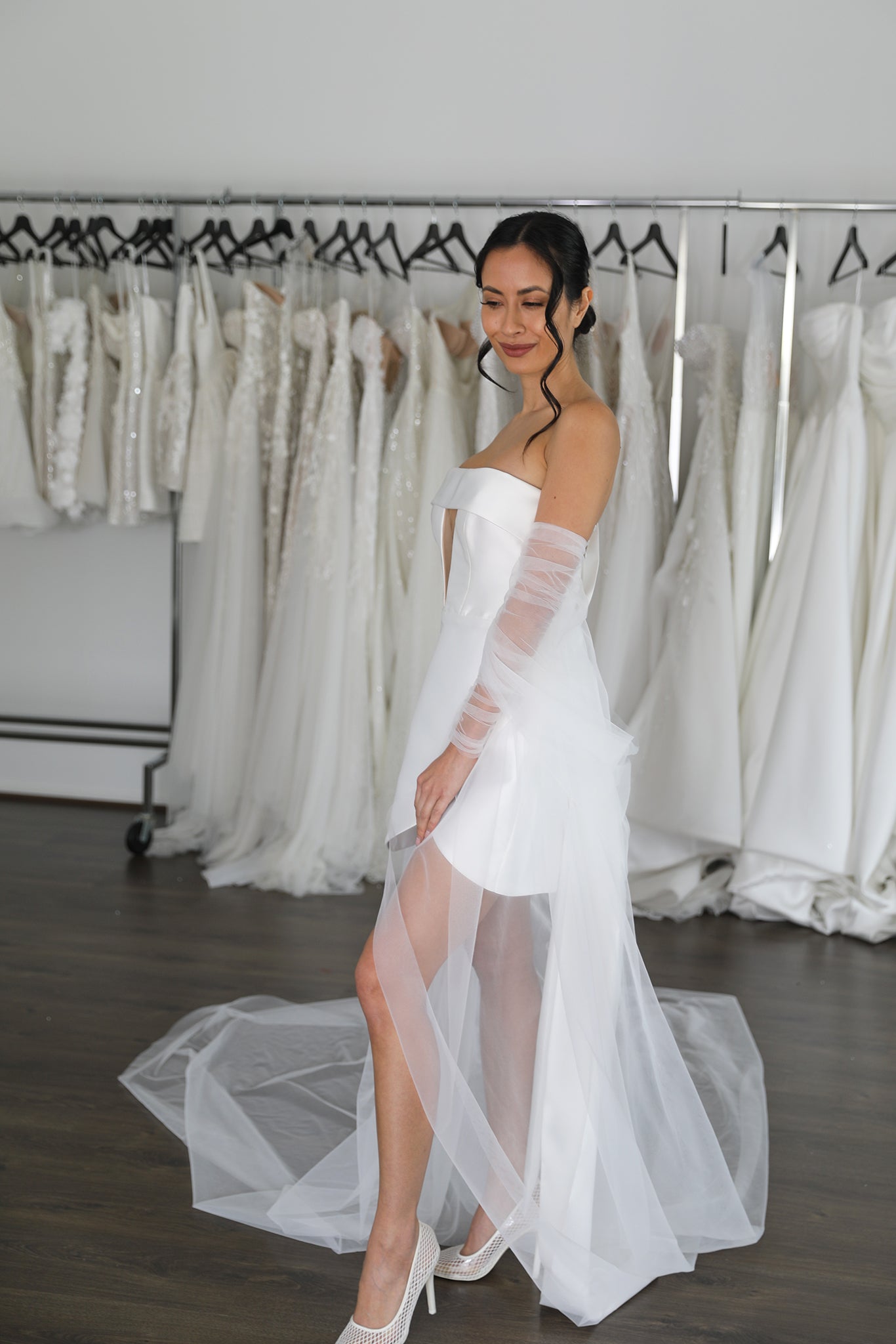 bride wearing wedding mini under tulle cape