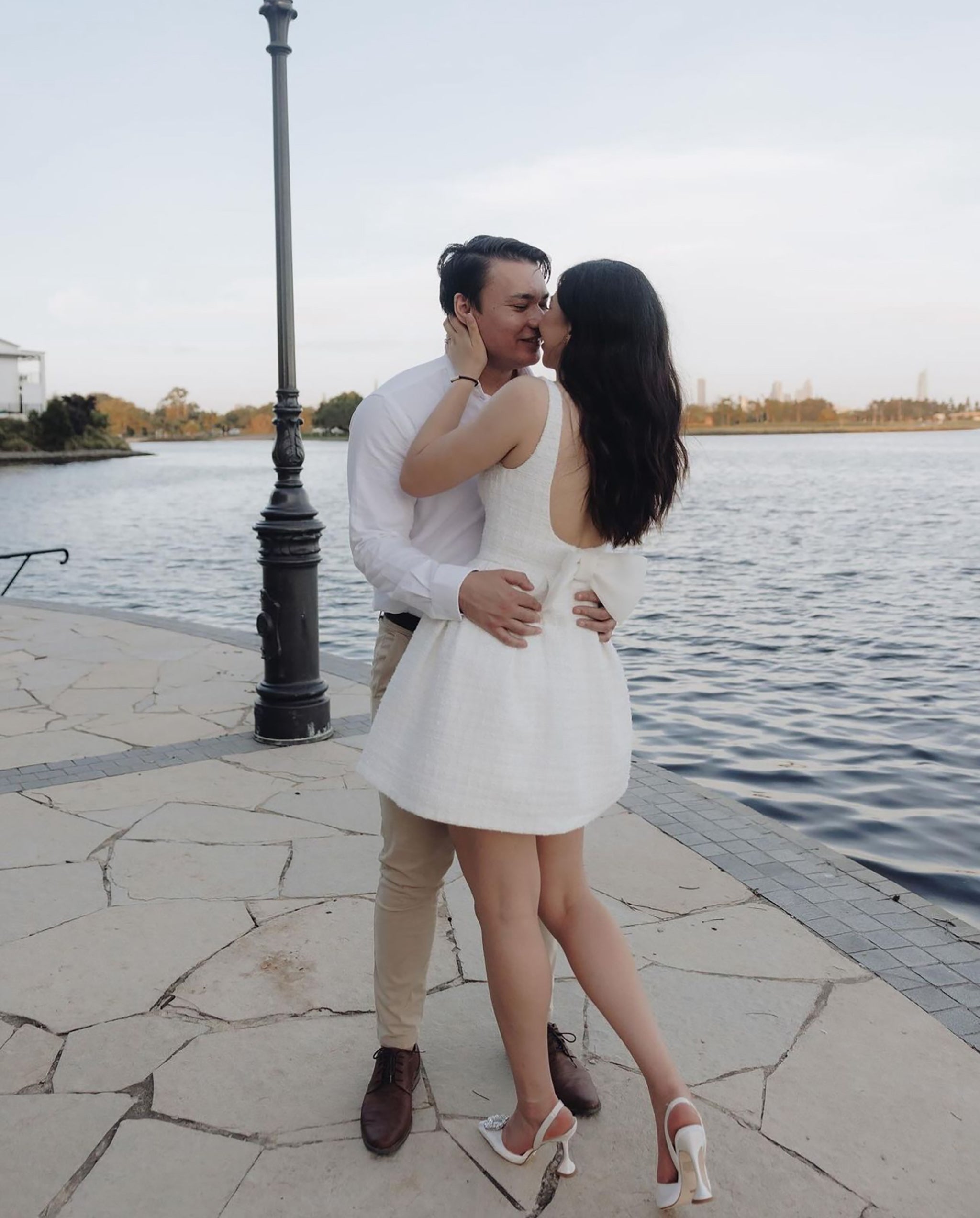 couple kissing by waters edge