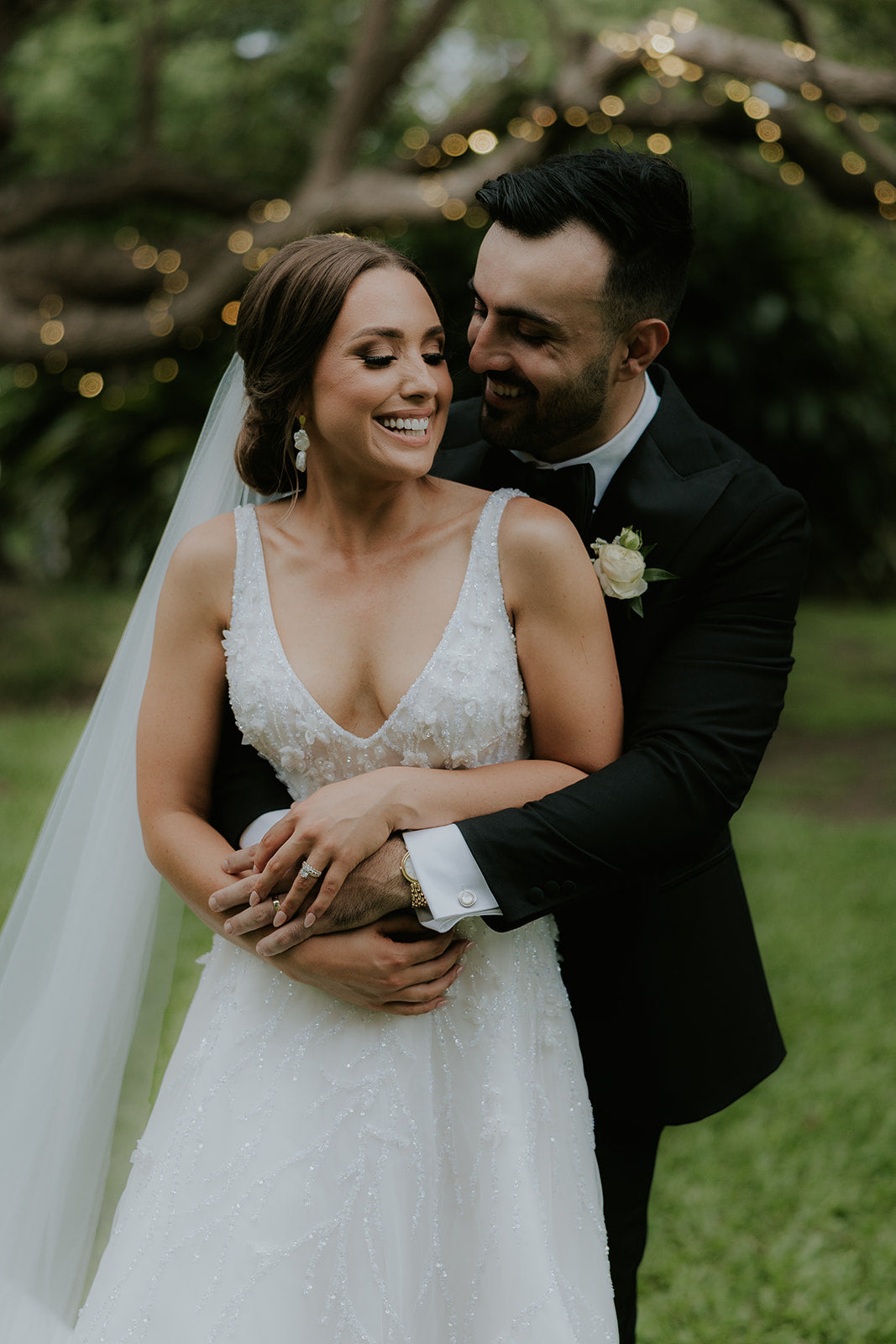 husband embracing wife on wedding day