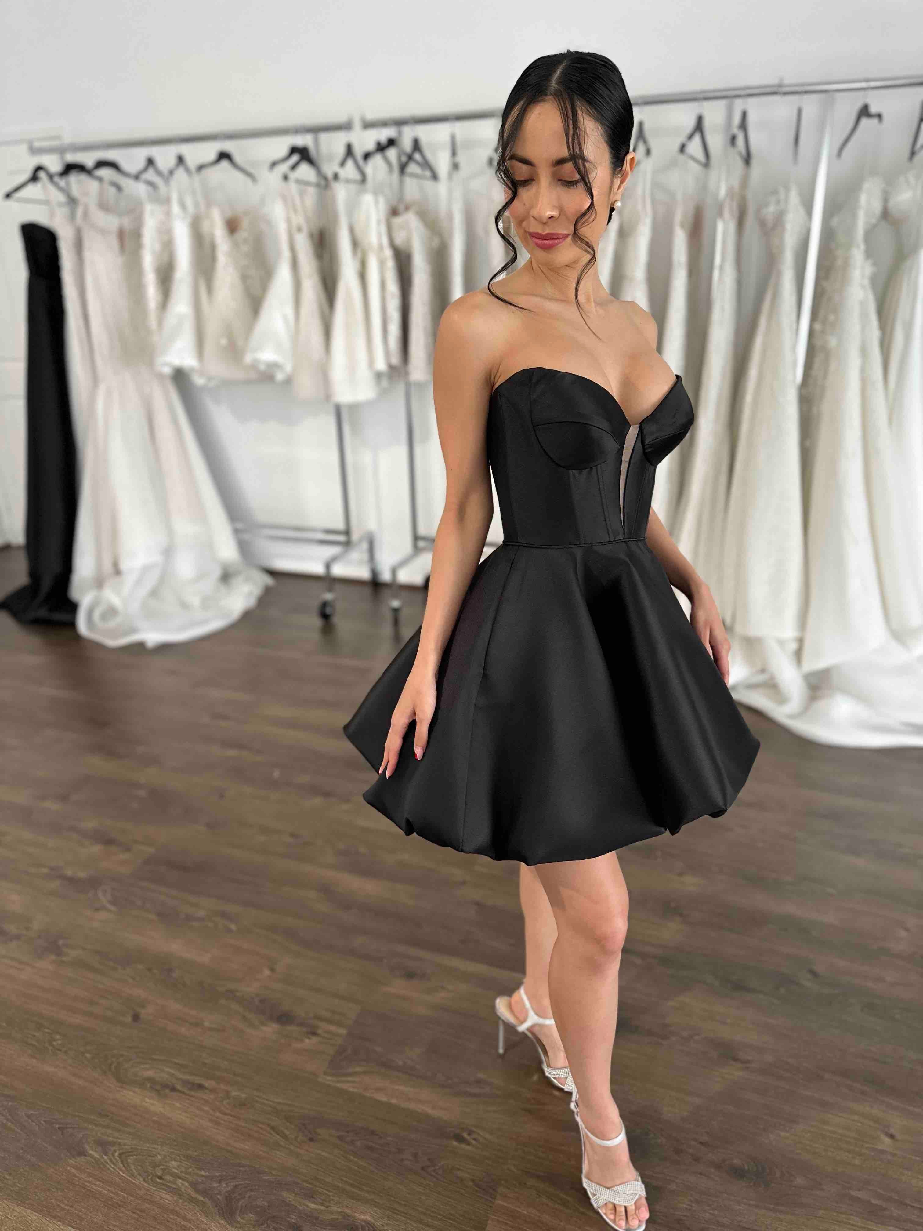 model posing in black short evening dress