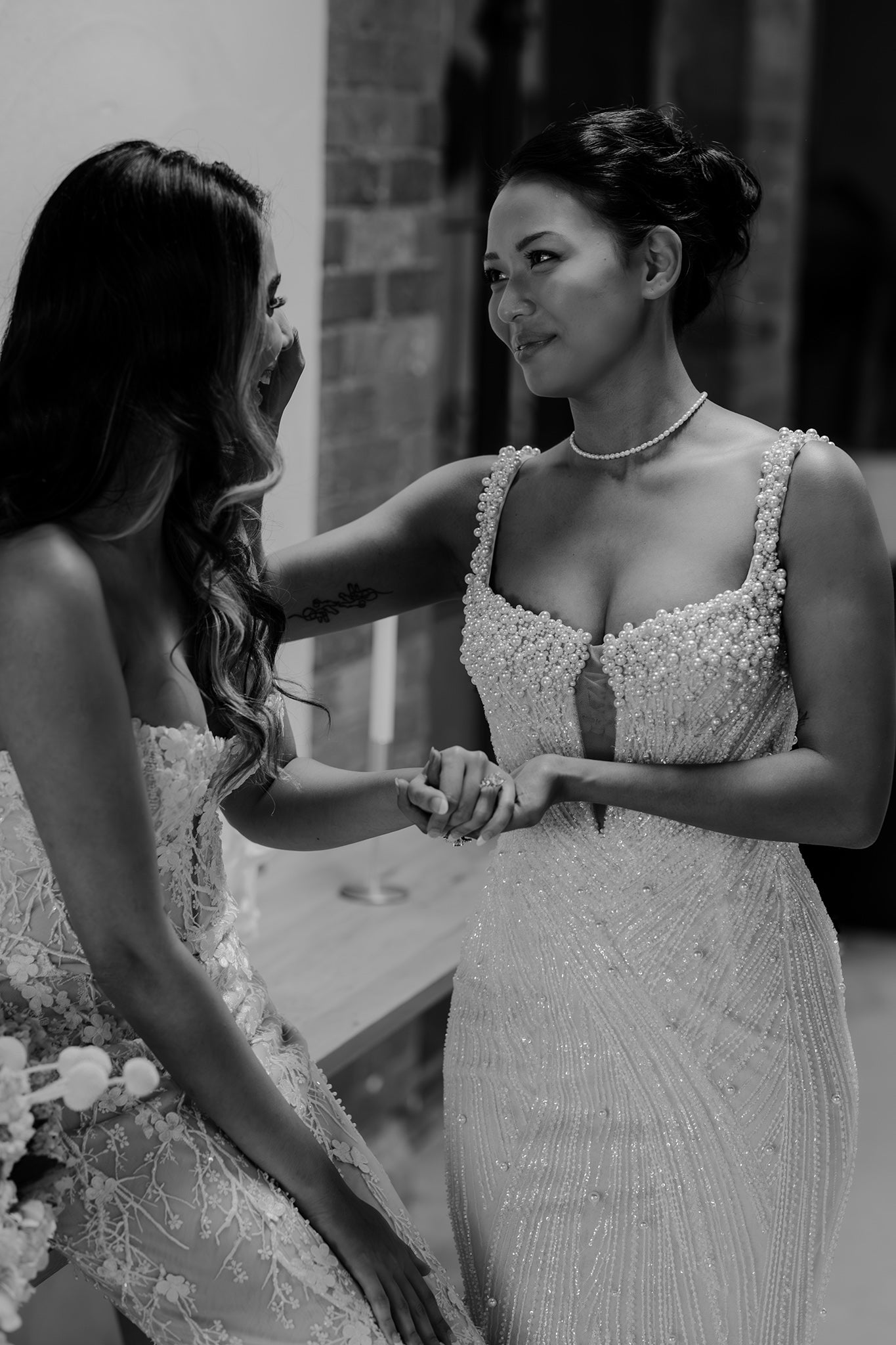 two brides hold hands on wedding day