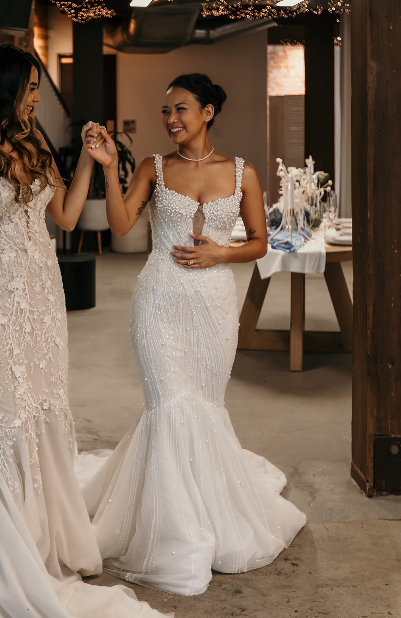two brides holding hands in wedding gowns