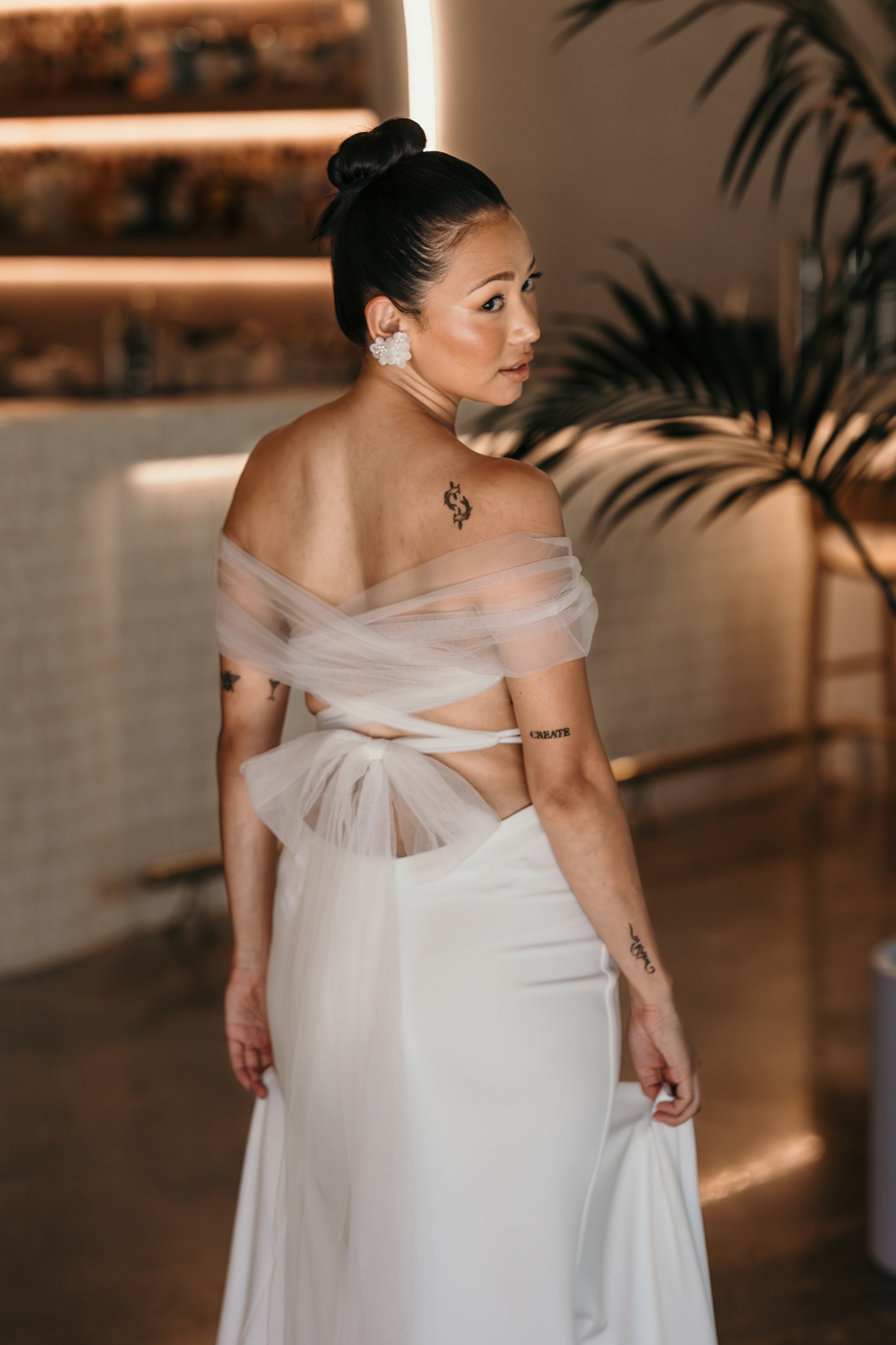 wedding dress with cross back straps tied up into a bow