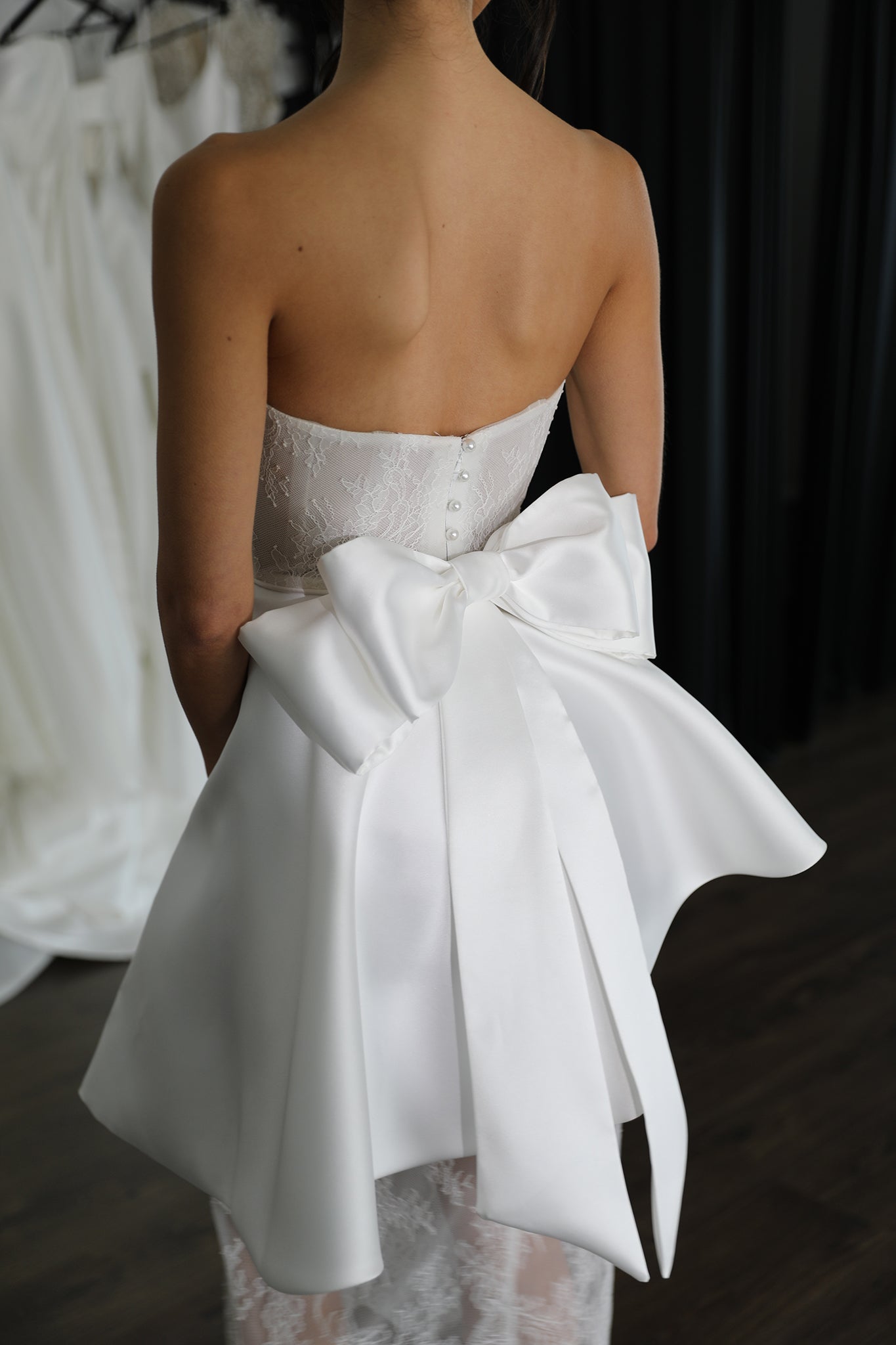 white detachable mikado bow on the back of brides