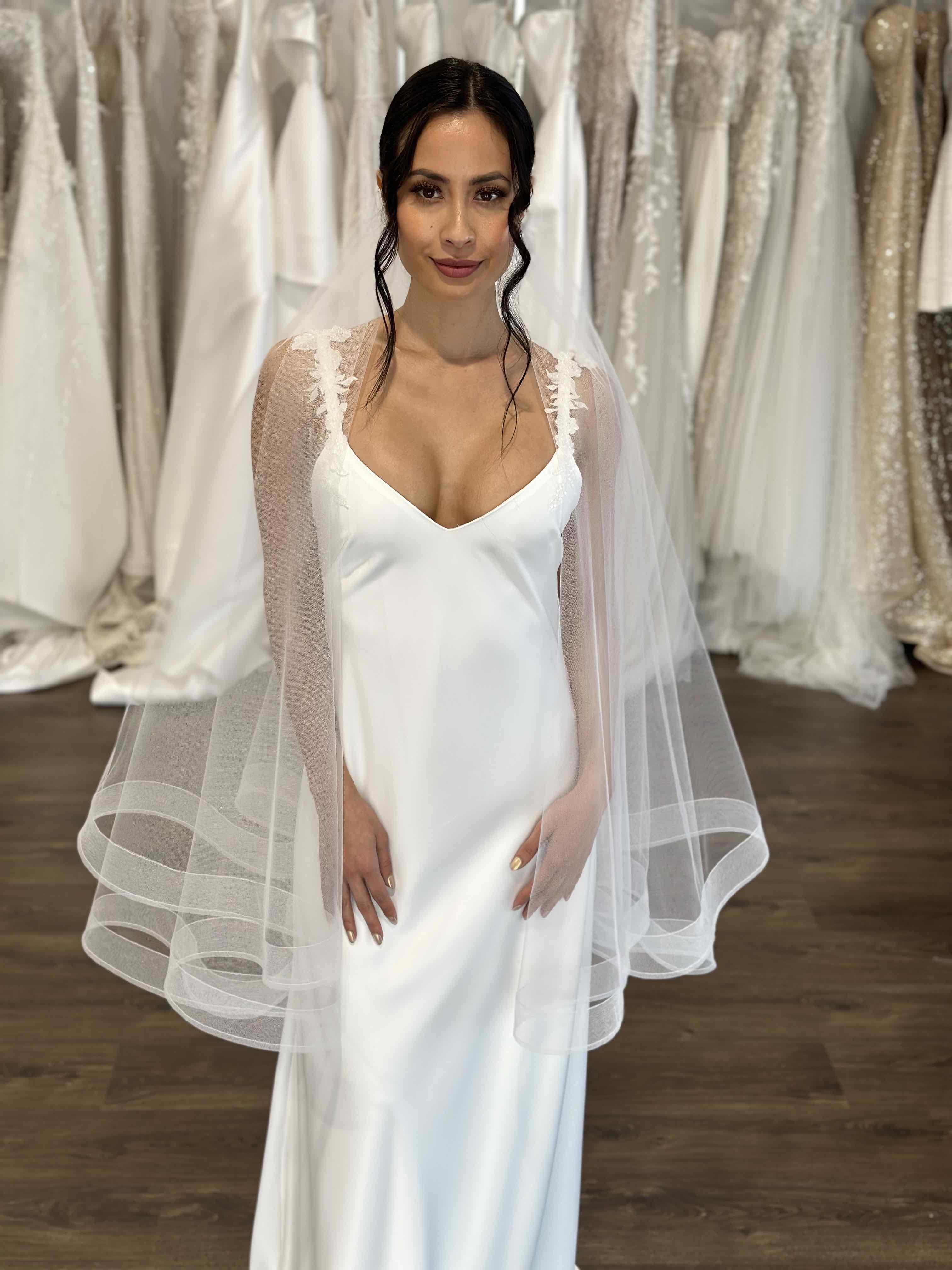 white dress with floral straps and tulle veil and crinoline hem
