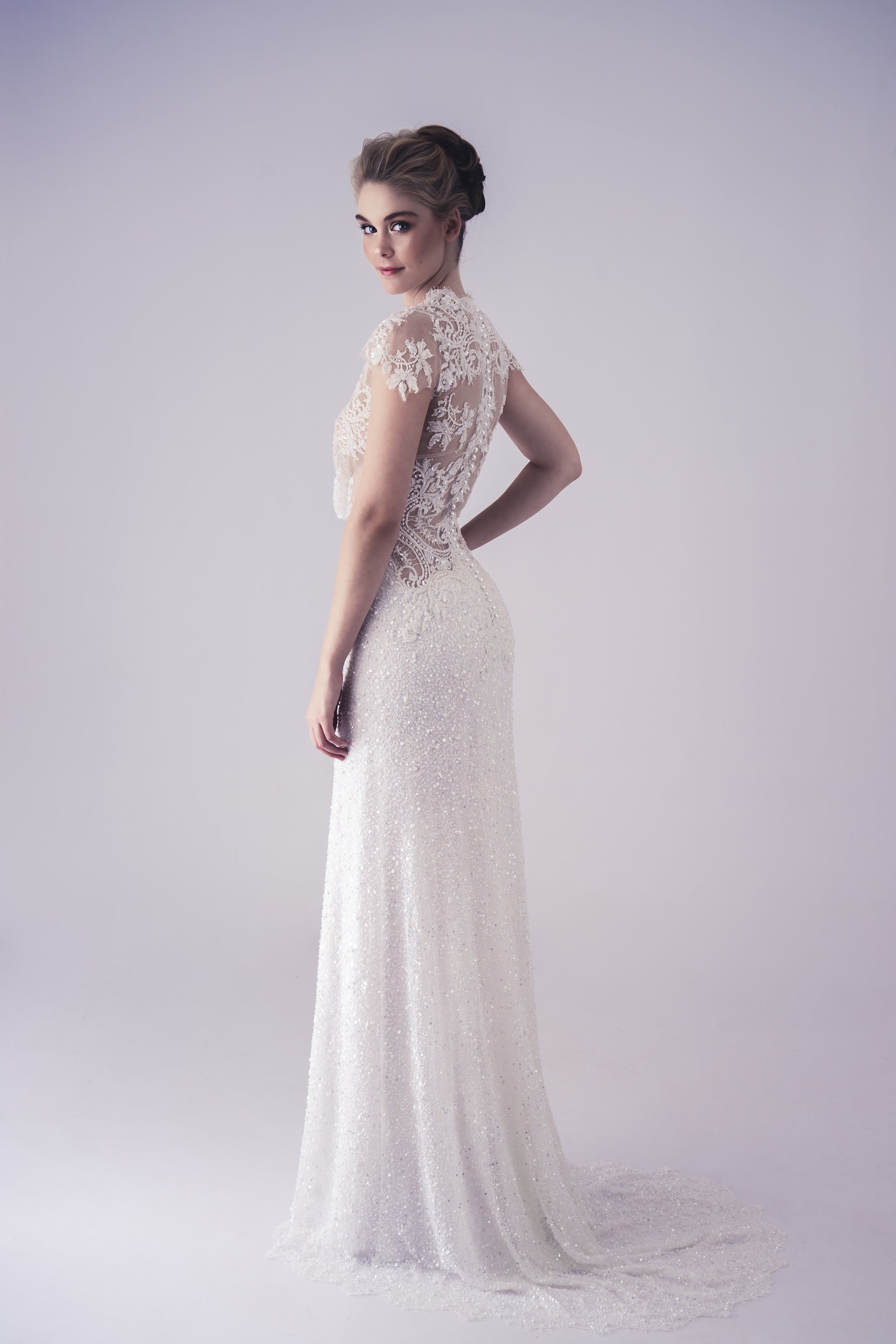 white fitted wedding gown with beaded lace design