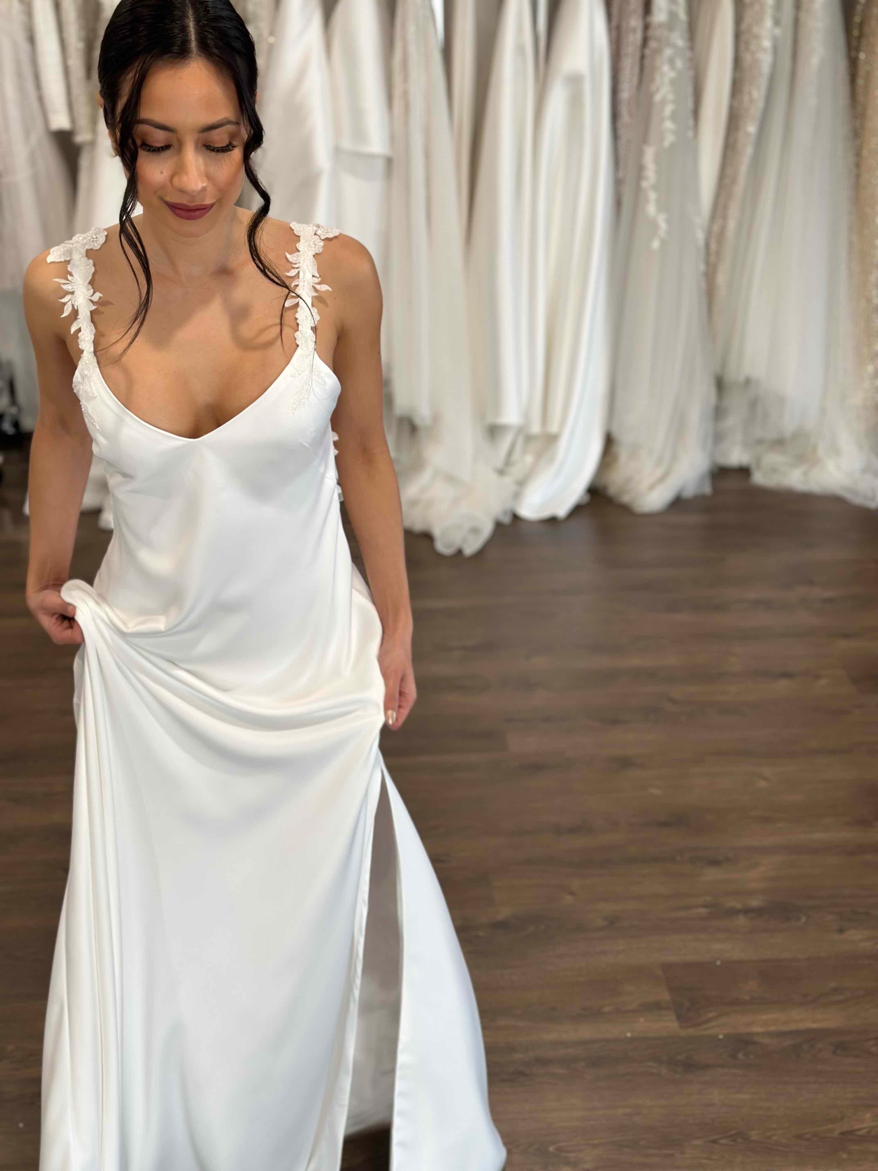 woman in bridal slip dress lifting skirt up slightly