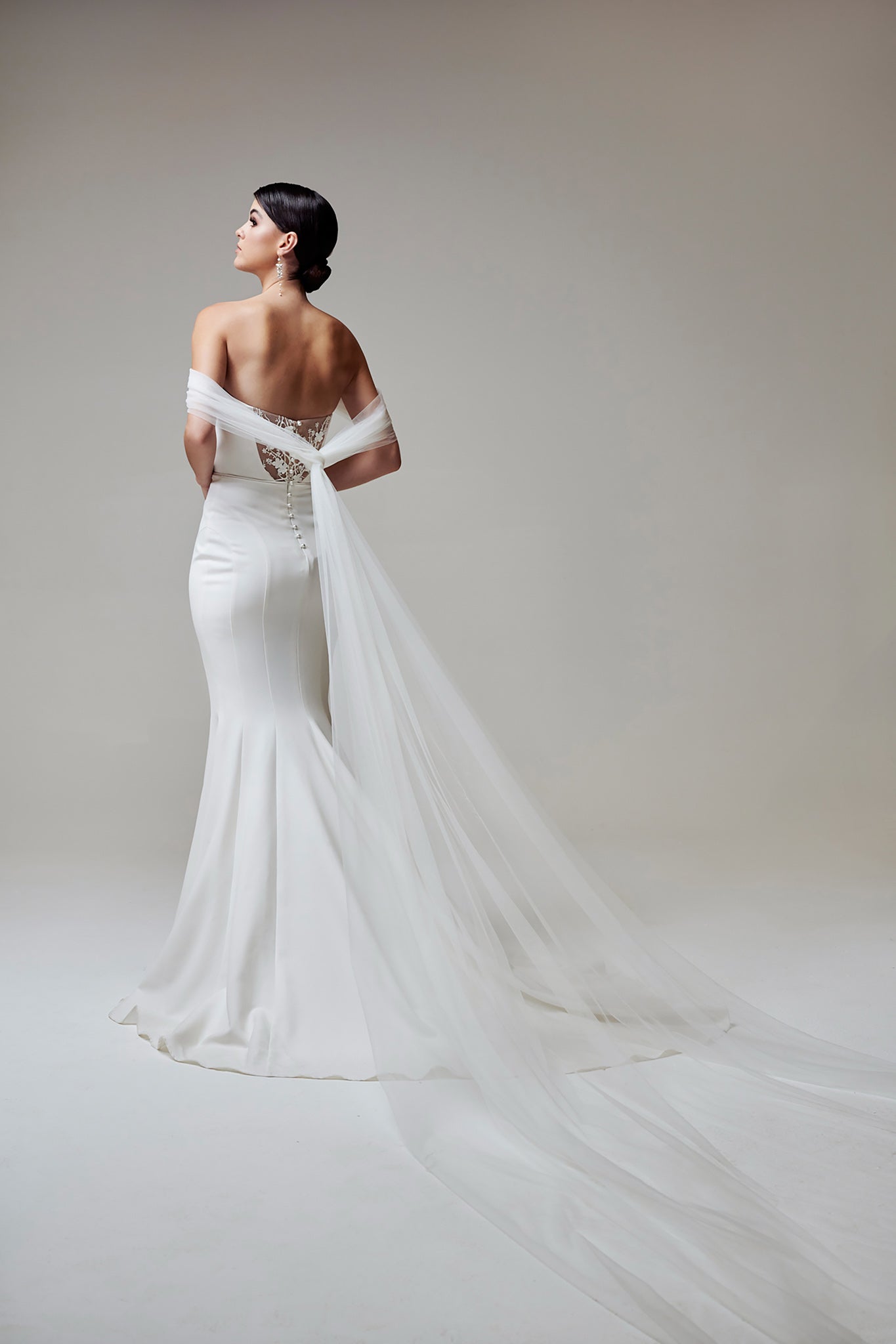 woman in strapless fitted wedding dress with tulle wings