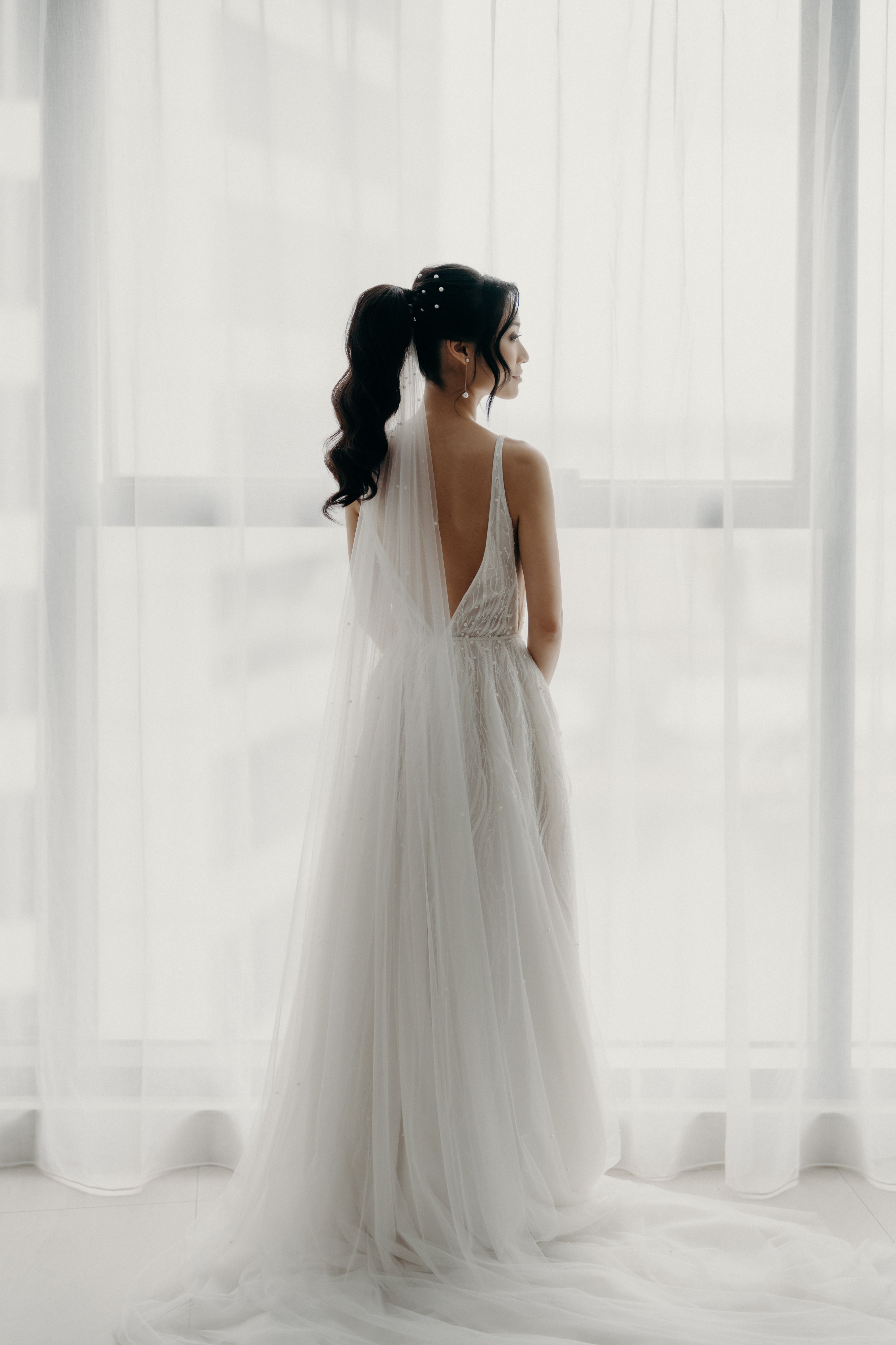 woman in wedding dress with wedding veil in her hair