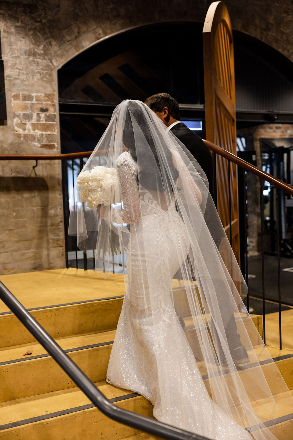 bride and her father walking up stairs