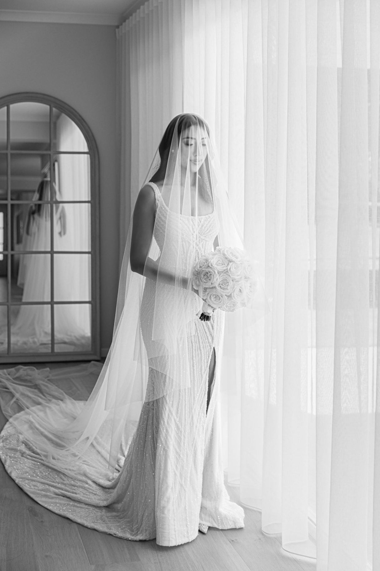 bride in lace wedding gown with full face veil