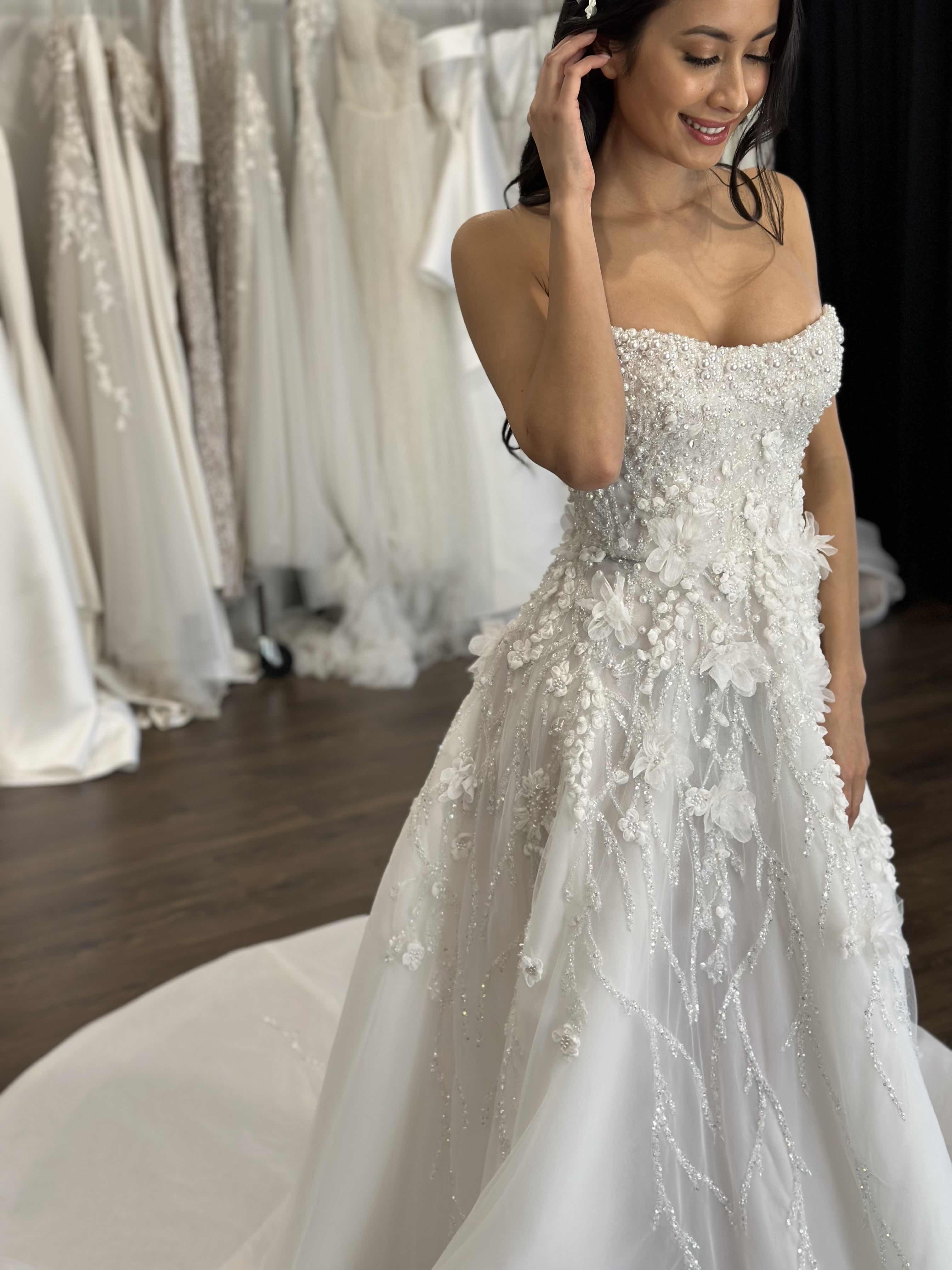 bride smiling as she runs her hand through her hair in wedding gown