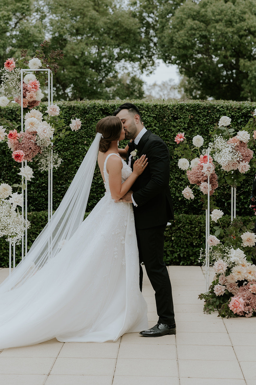 husband kissing wife at wedding ceremony