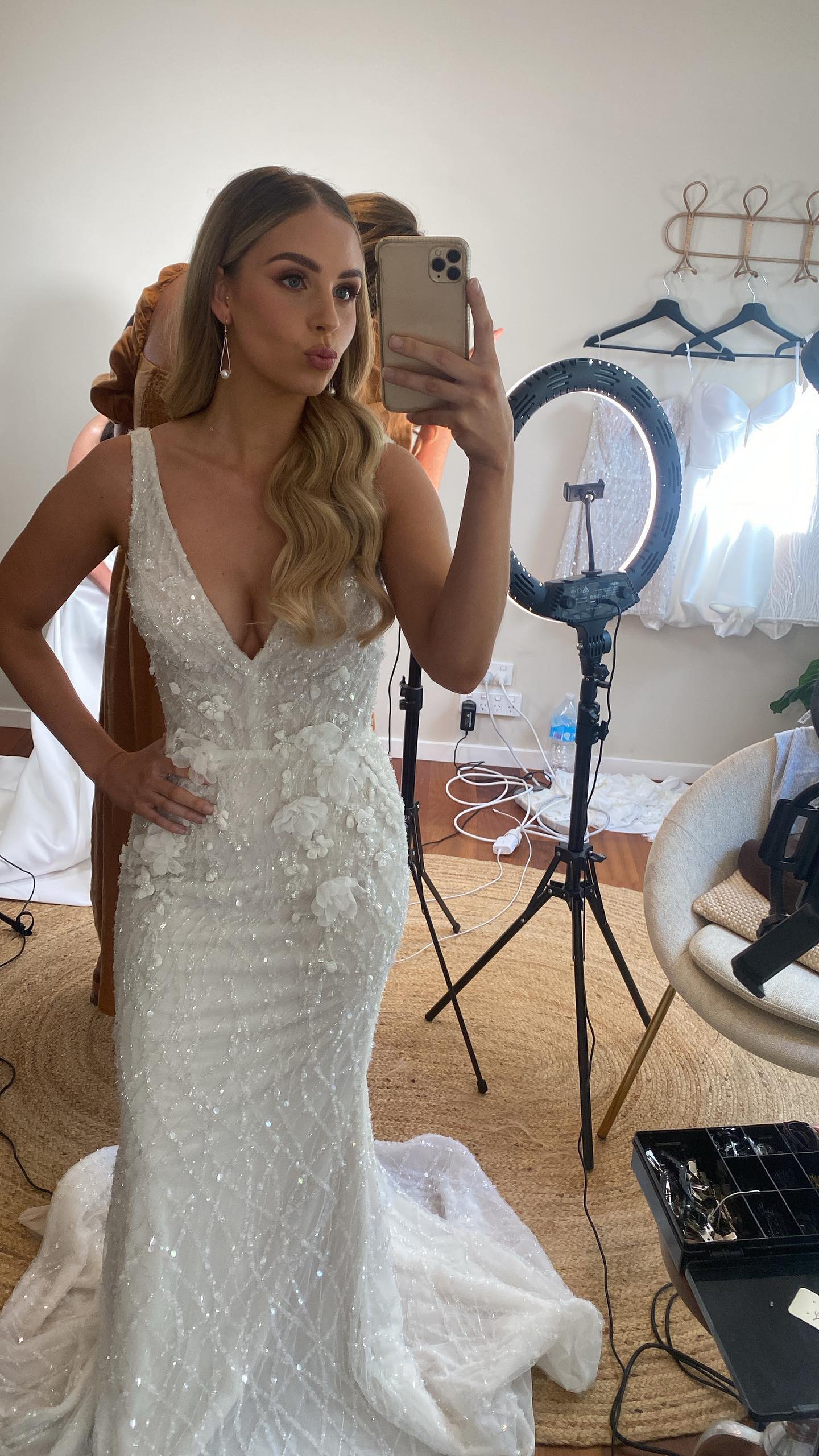 model posing for selfie in beaded wedding dress