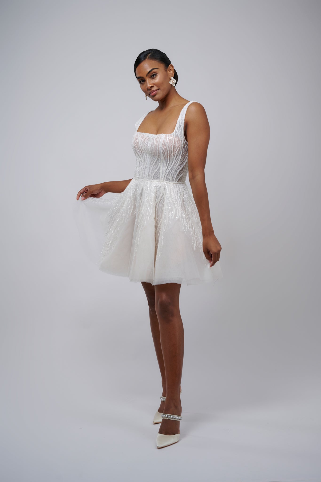 model posing in lace mini wedding dress with U-neck