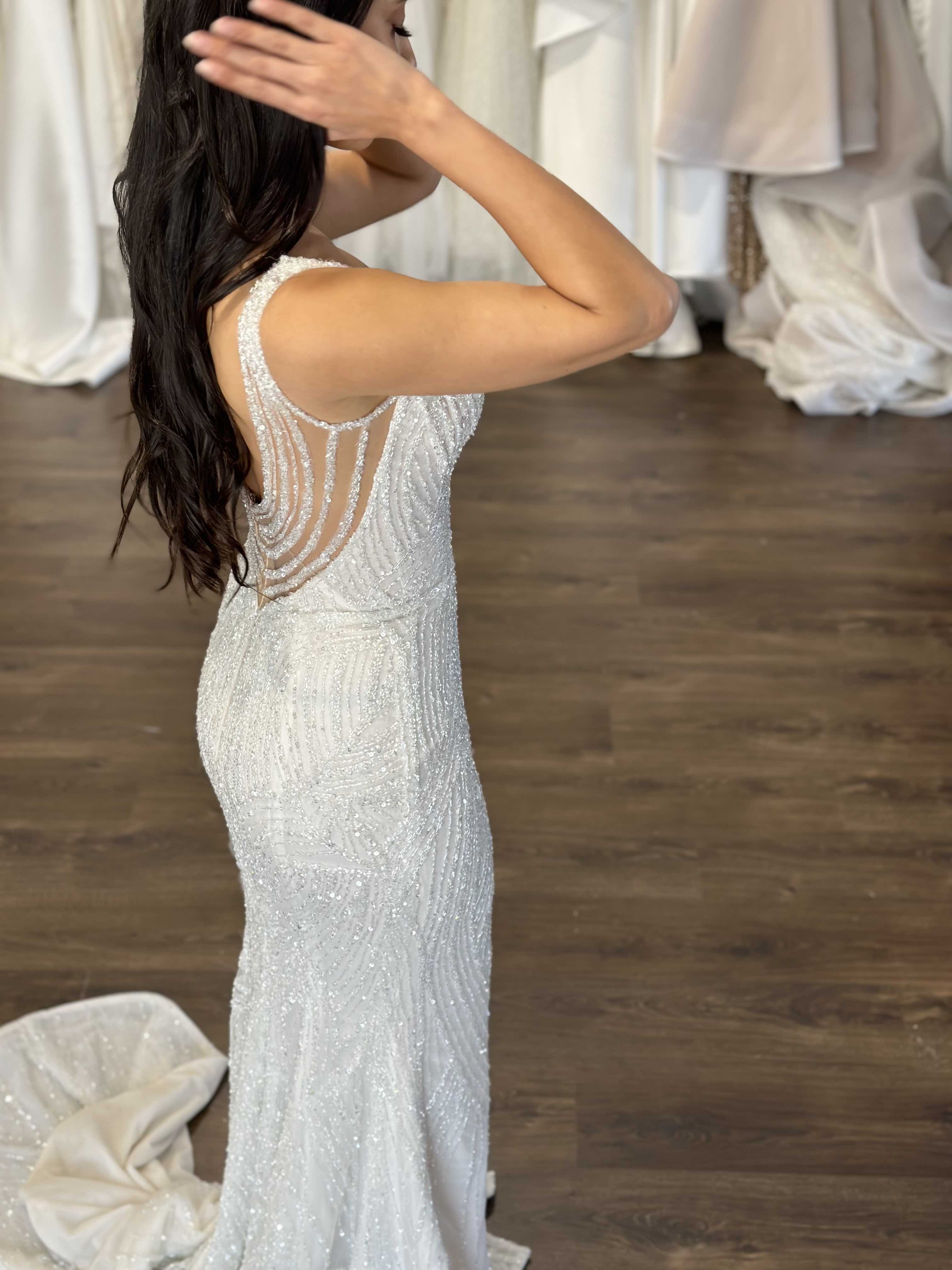 woman running her hands through her hair in lace wedding gown