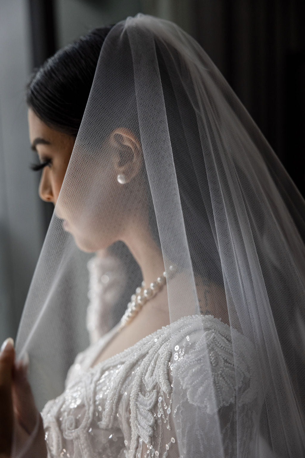 woman wearing wedding veil and lace dress