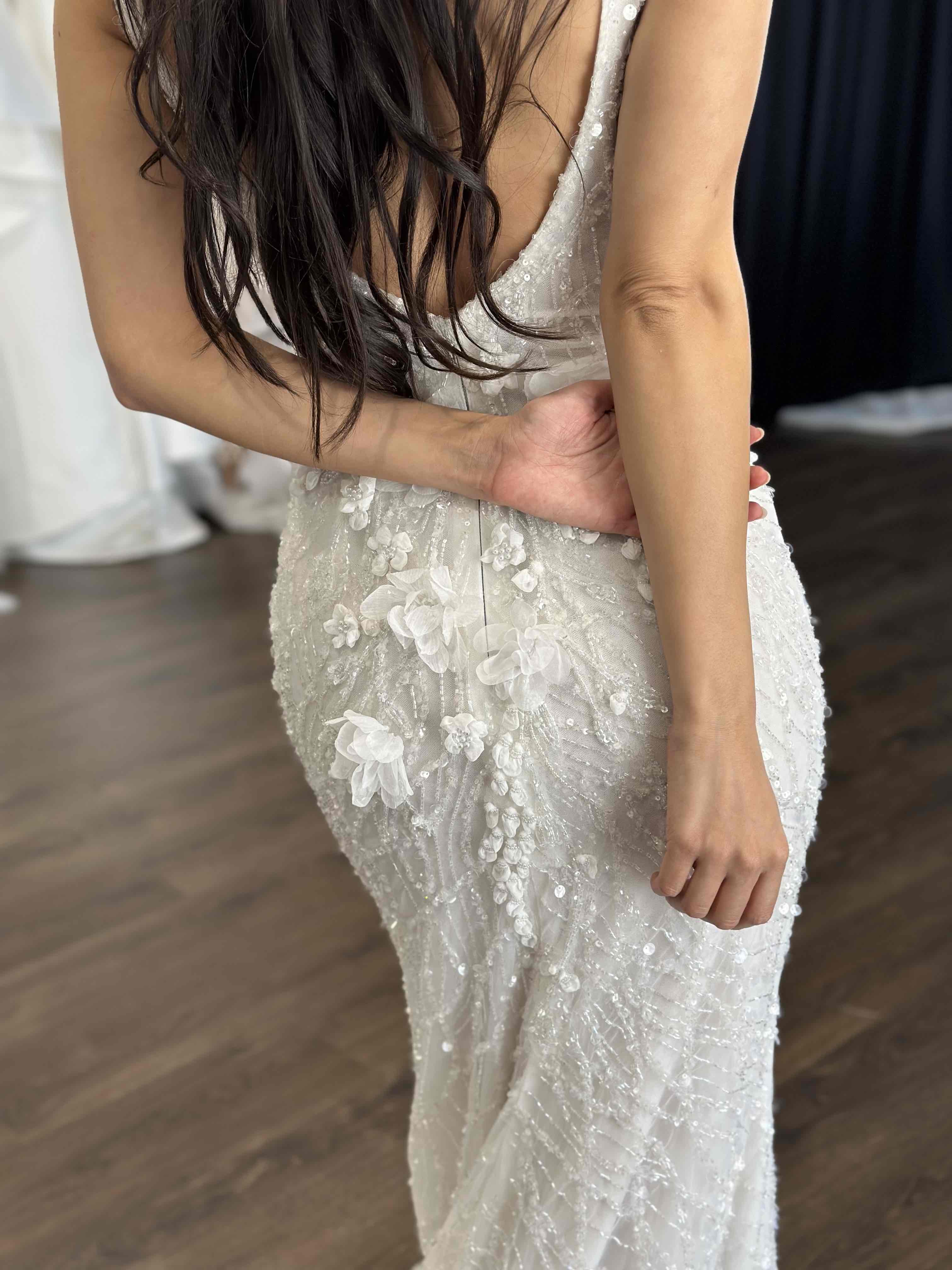woman with arms crossed over her back in lace wedding dress