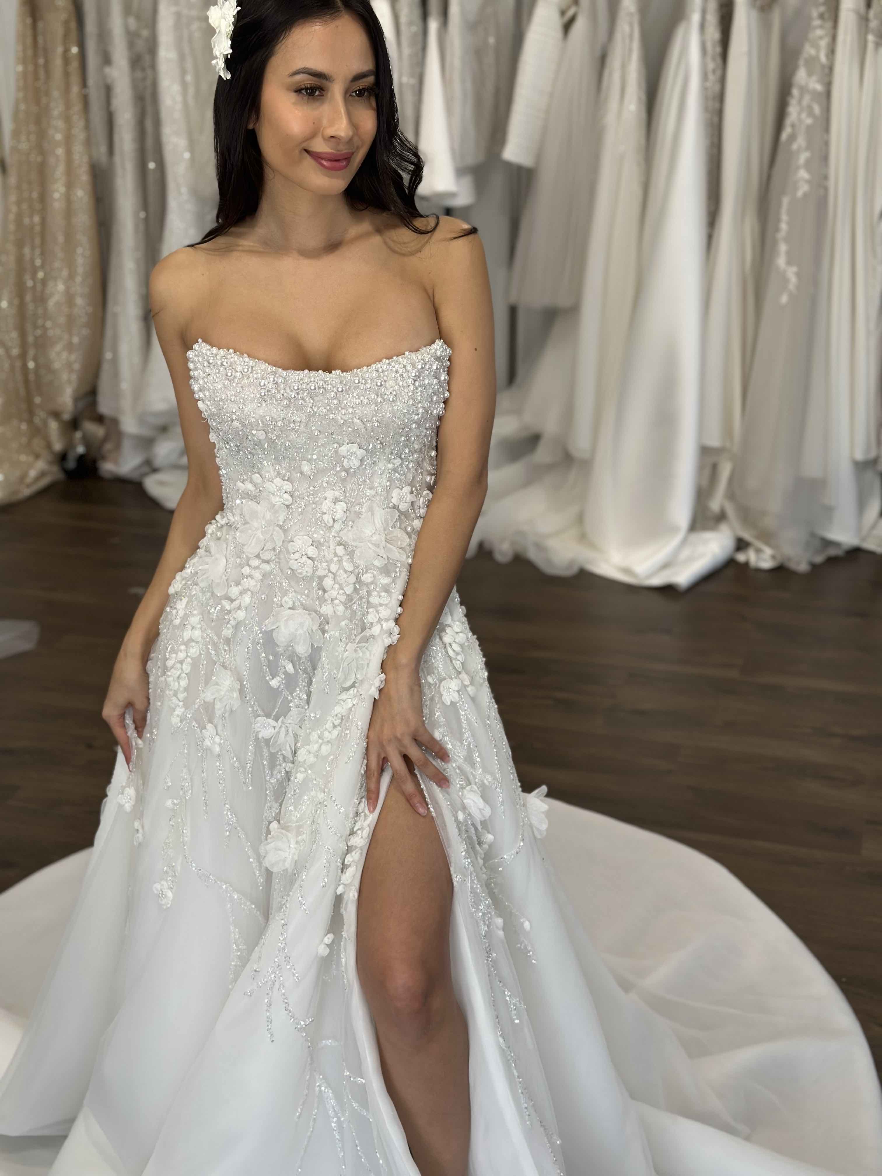 woman with thigh high split on her strapless wedding dress