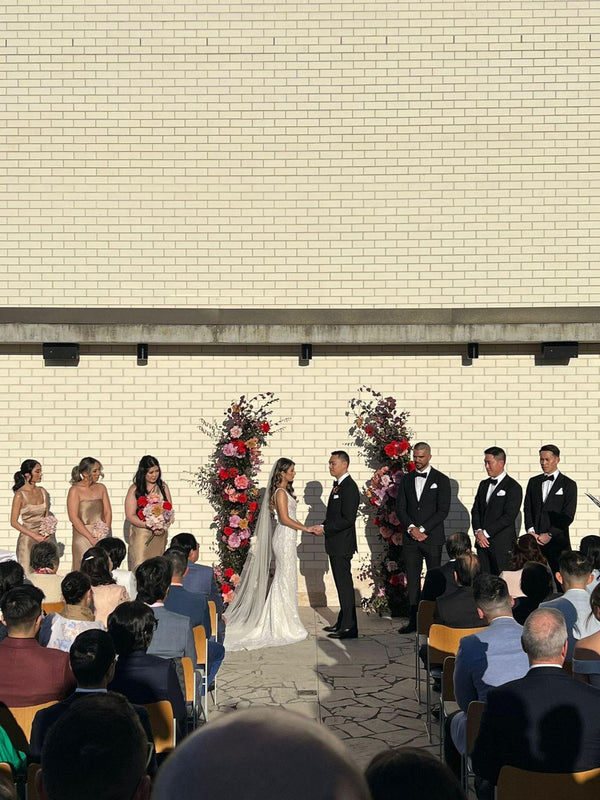 bride and groom exchanging vows surrounded by friends