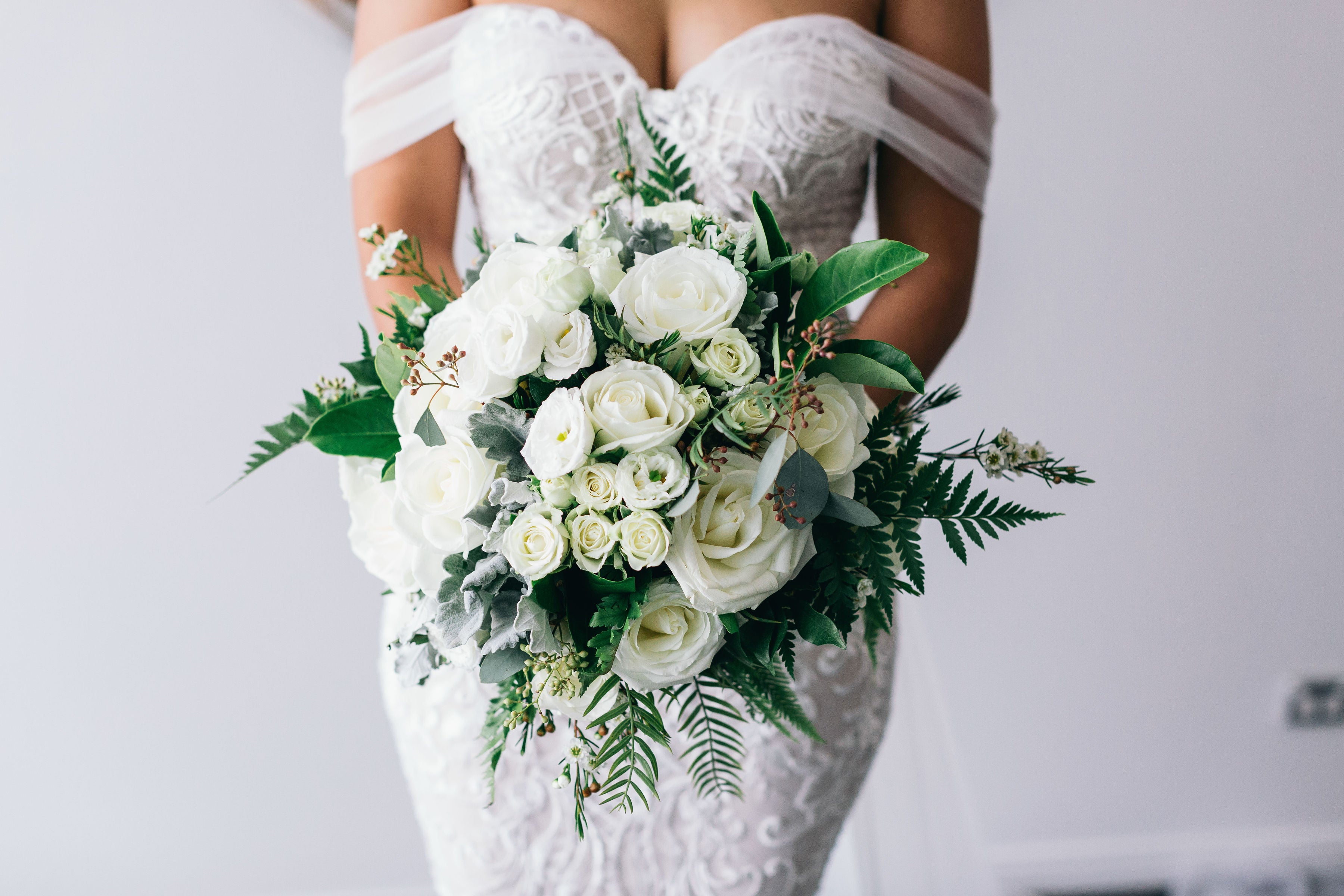 bride wearing wedding dress holding bouquet of flowers